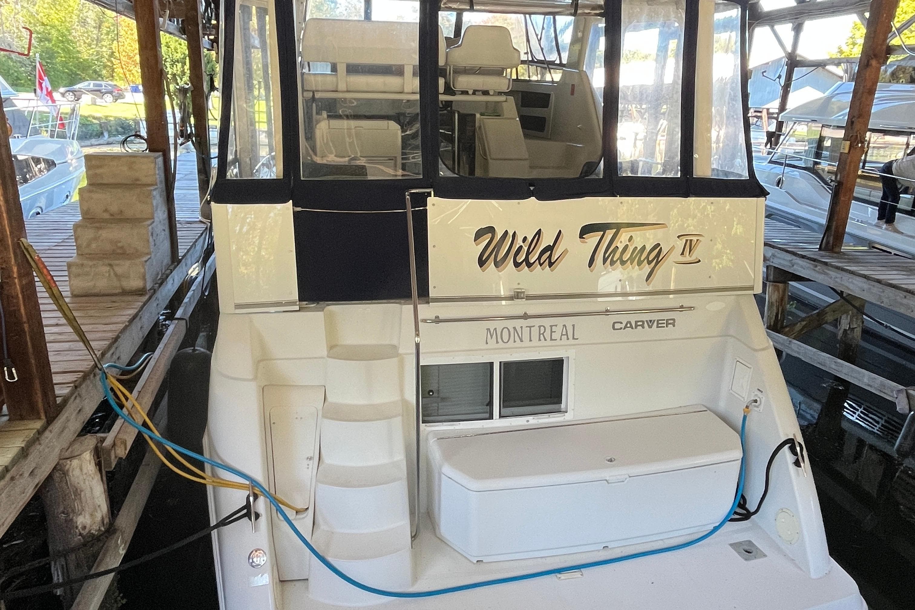 1996 Carver 355 Aft Cabin Motor Yacht docked, named "Wild Thing IV," with visible seating area.