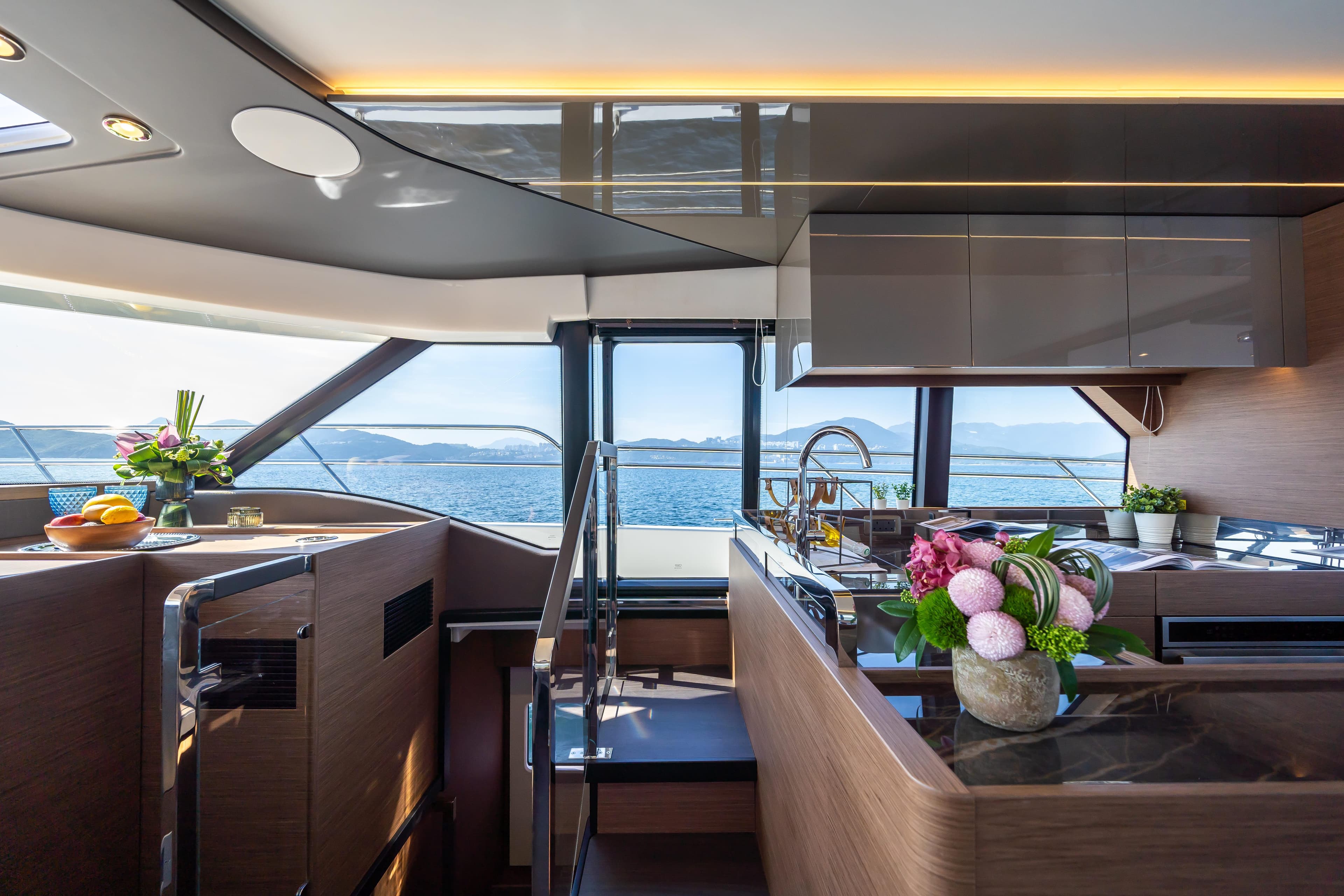 Luxurious interior of 2025 Prestige M48 yacht with modern kitchen and ocean view.
