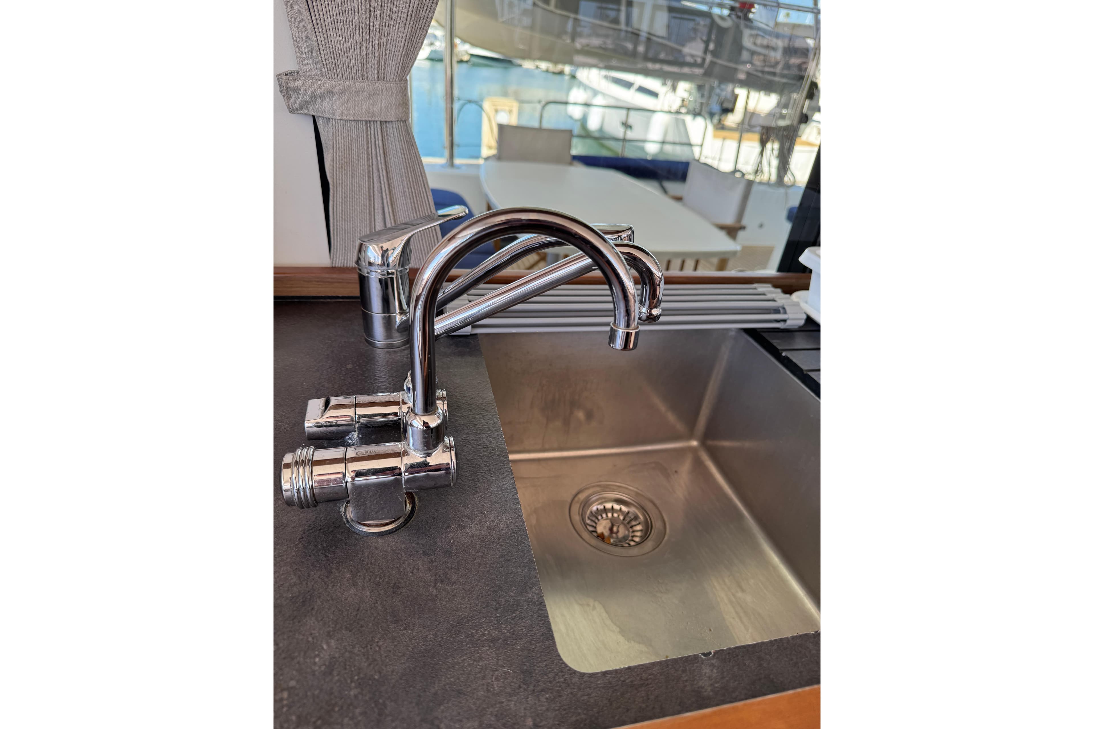 Modern kitchen sink and faucet on 2020 Lagoon 42 yacht interior.