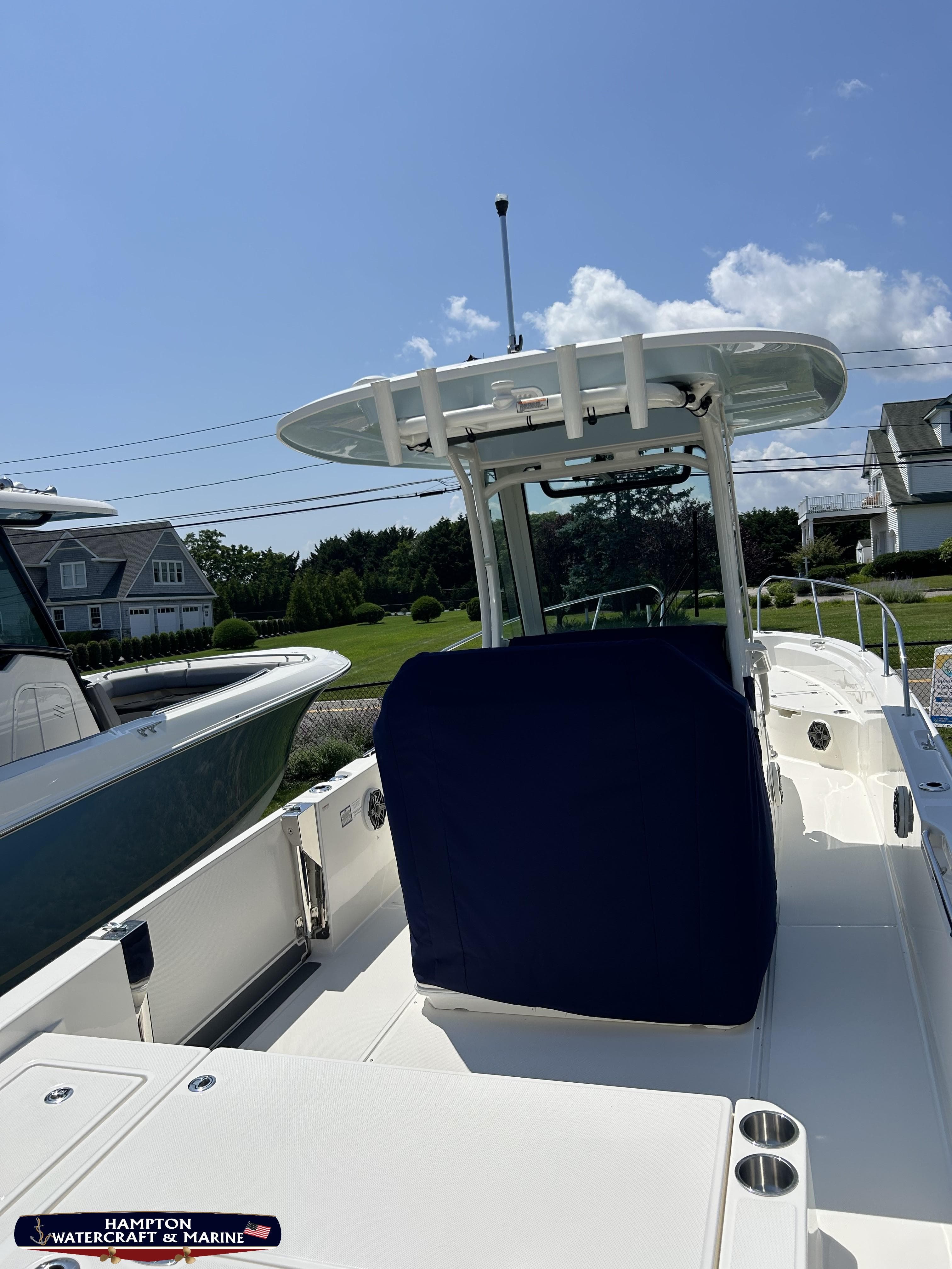 2023 Boston Whaler 280 Dauntless boat docked under clear blue sky.