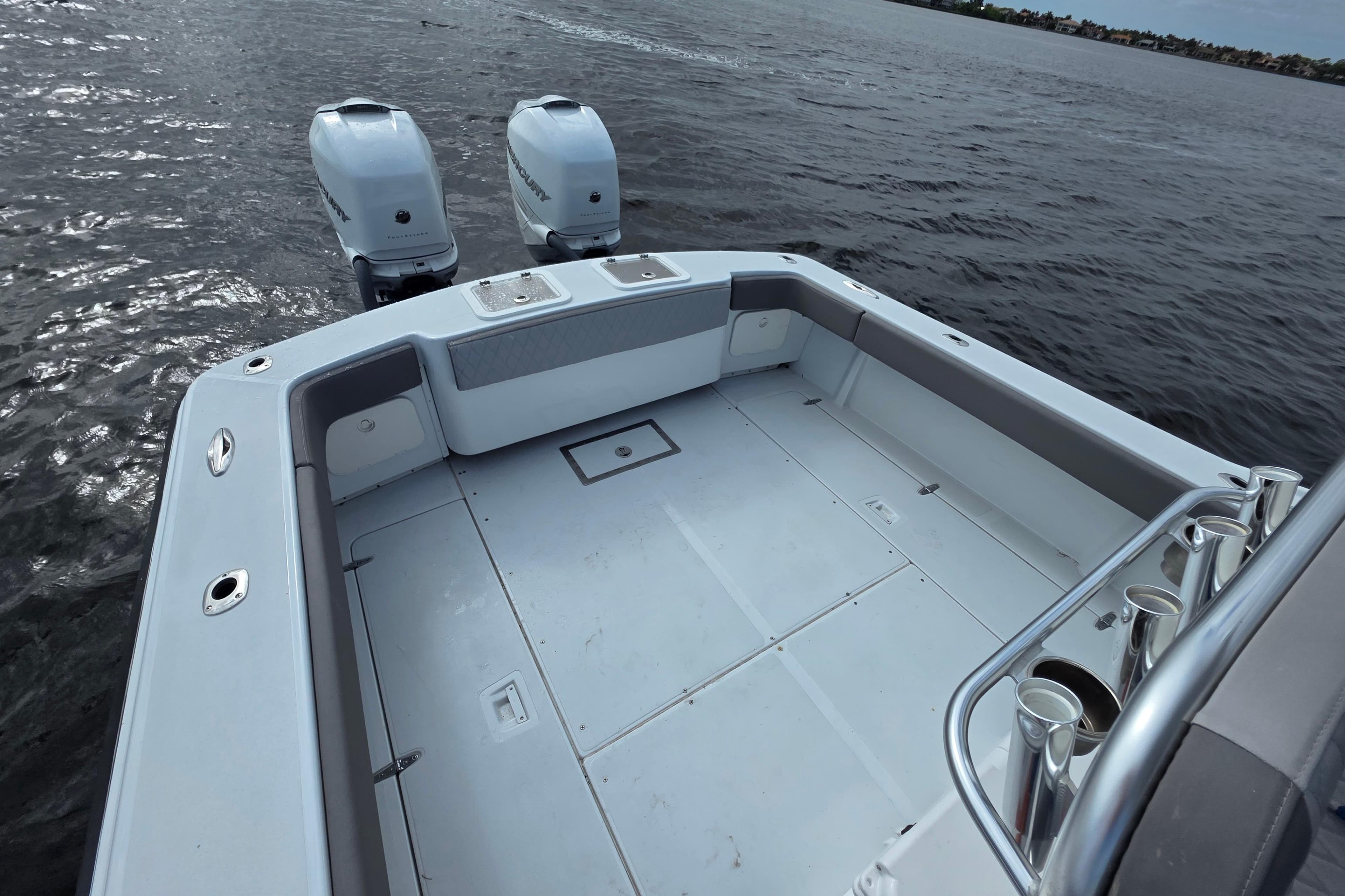 1984 Rybovich Rybo Runner boat deck with dual outboard motors on calm water.