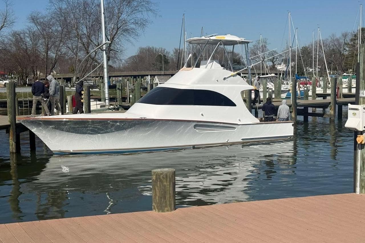 2026 Weaver Sportfish yacht docked at marina with people nearby.