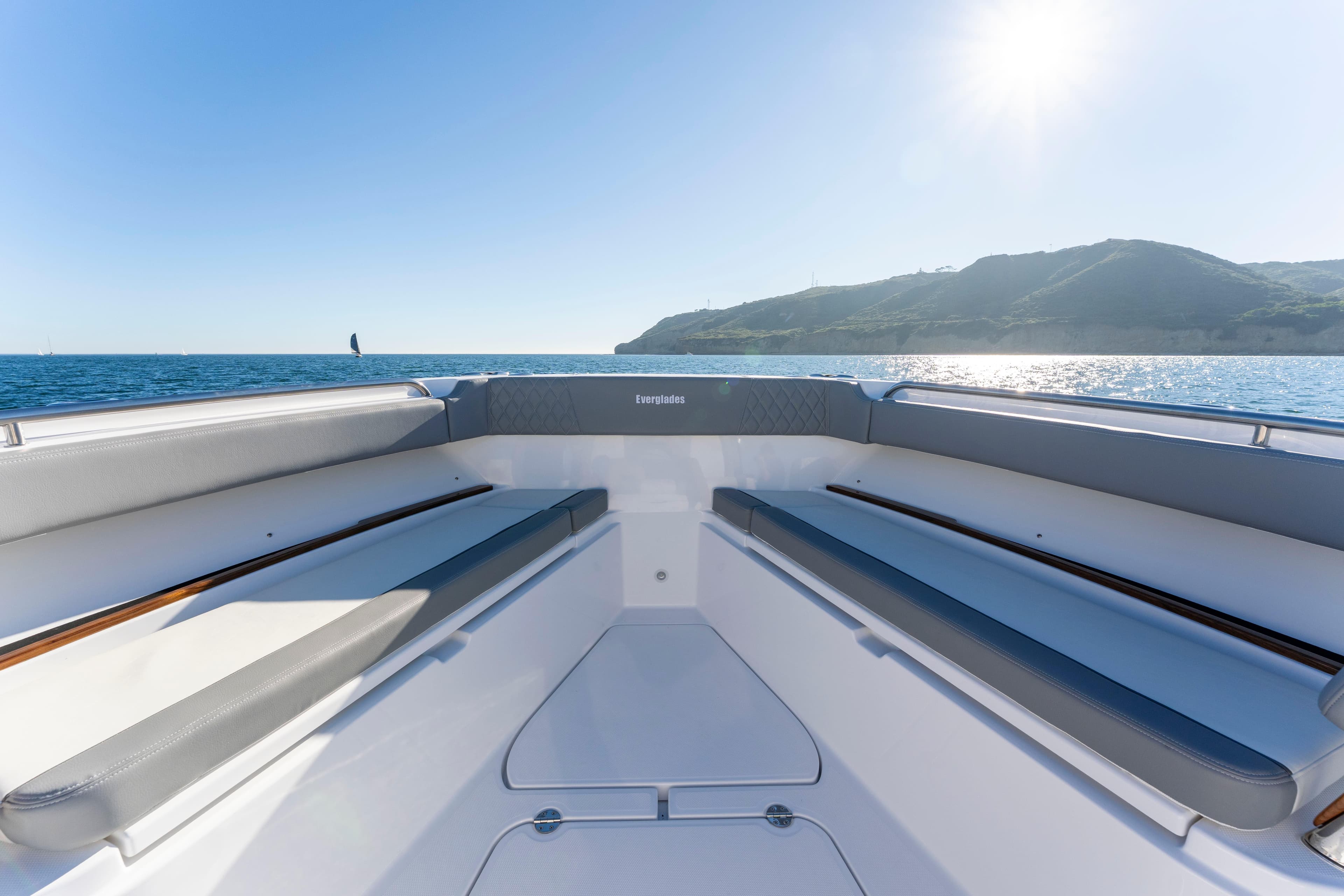 Everglades 455 Center Console 2026 on calm sea with sunny sky.