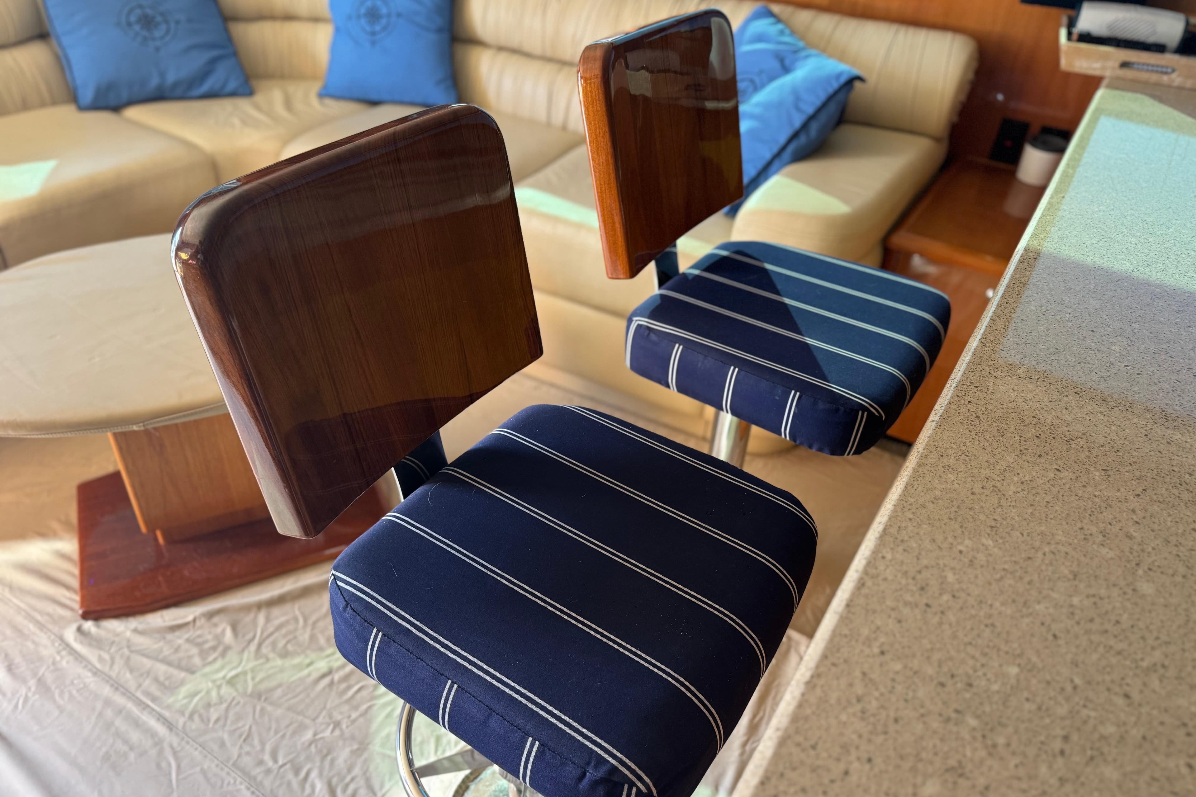 Luxurious interior of 2002 Viking 61 Enclosed Bridge with stylish bar stools and seating.
