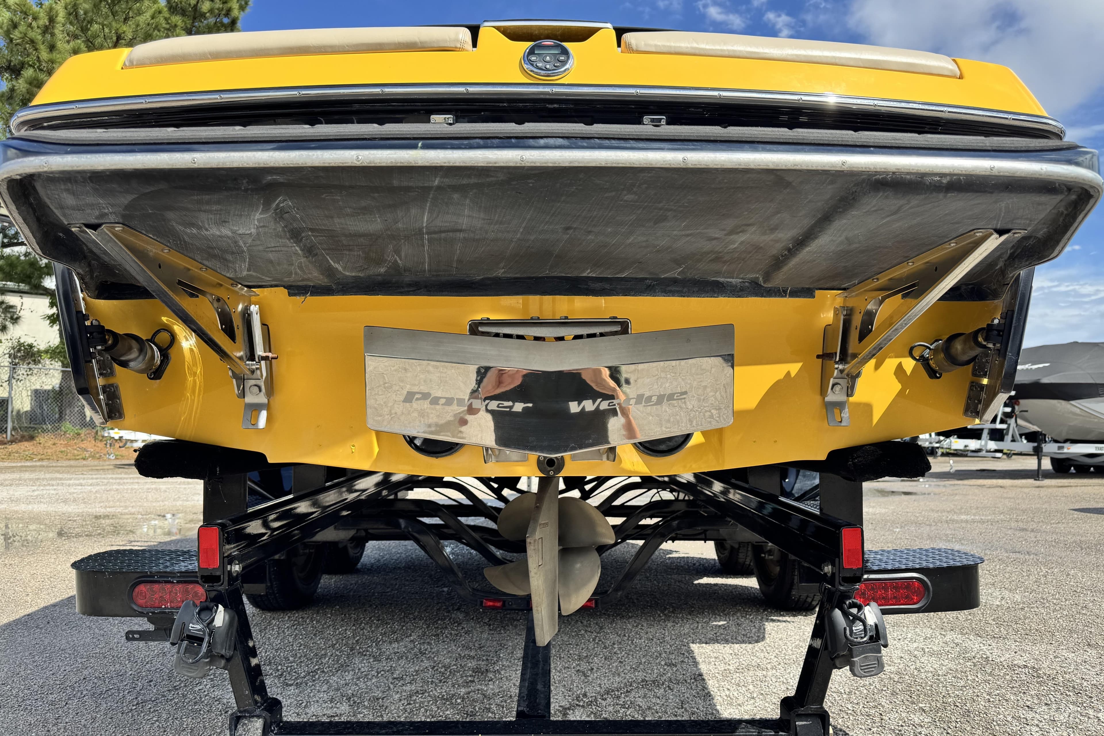 Rear view of a 2013 Malibu Wakesetter 24 MXZ boat on a trailer.