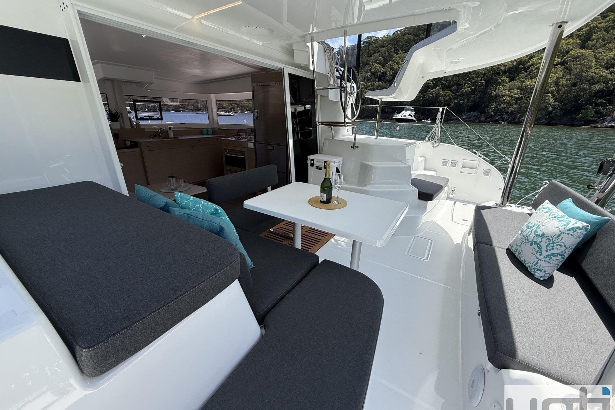 Luxurious Lagoon 38 catamaran interior, 2026 model, featuring elegant seating and scenic water views.