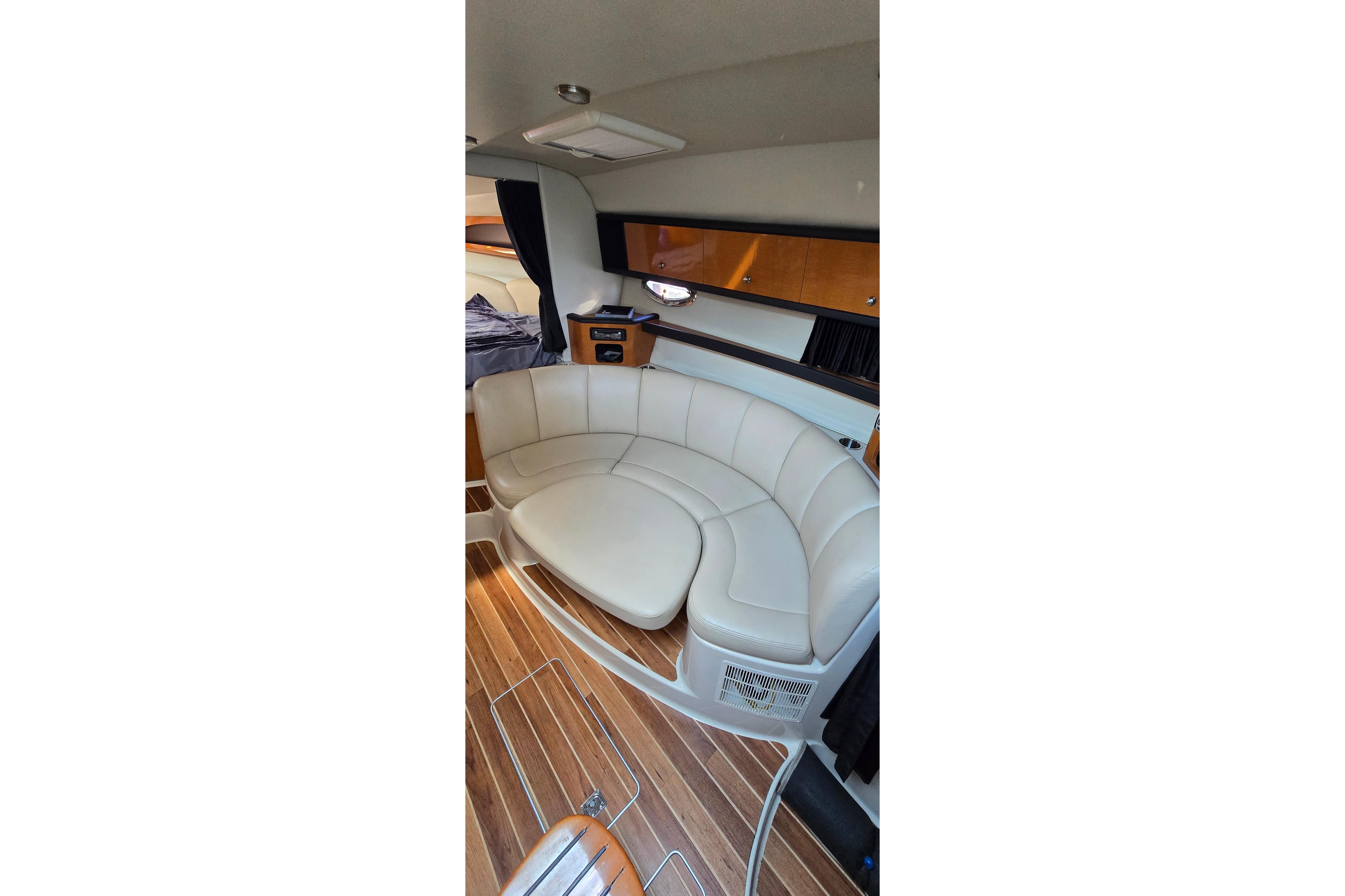 Interior of 2009 Chaparral Signature 310 yacht with curved seating and wood flooring.
