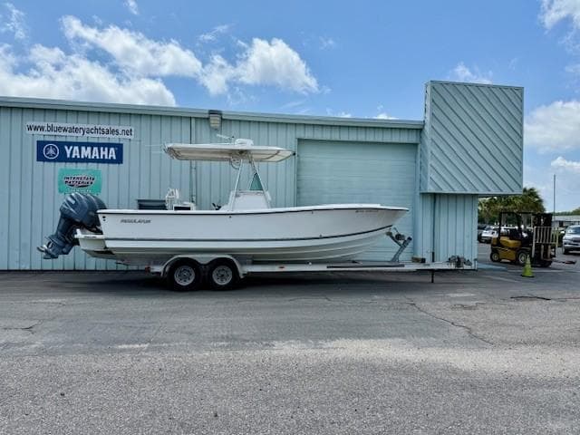 2001 Regulator 26 Forward Seating boat on trailer outside dealership.