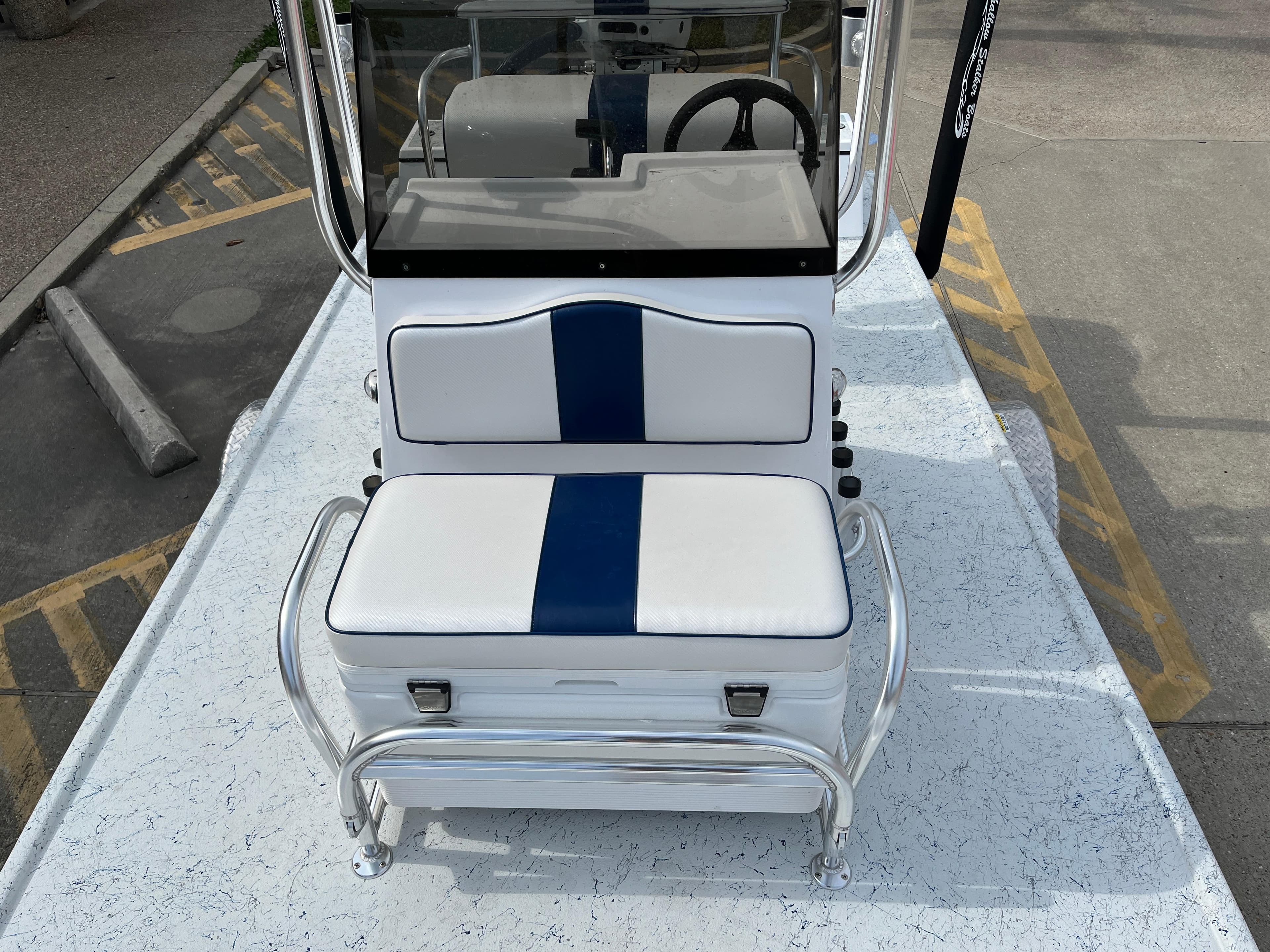 2024 Shallow Stalker SS-17 Sportsman boat with white and blue seating.