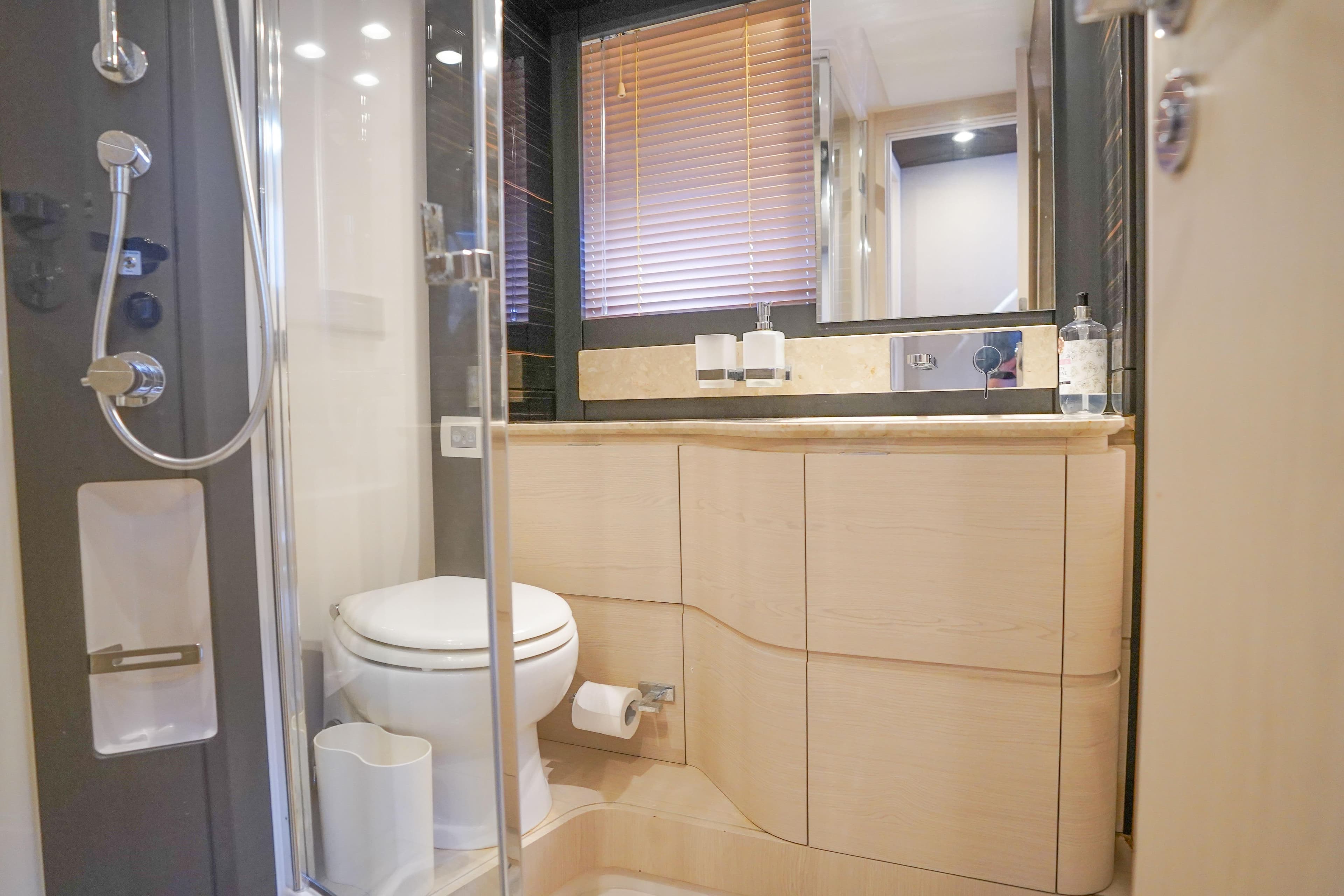Luxurious bathroom in 2017 Azimut 66 Flybridge yacht with modern fixtures and elegant design.