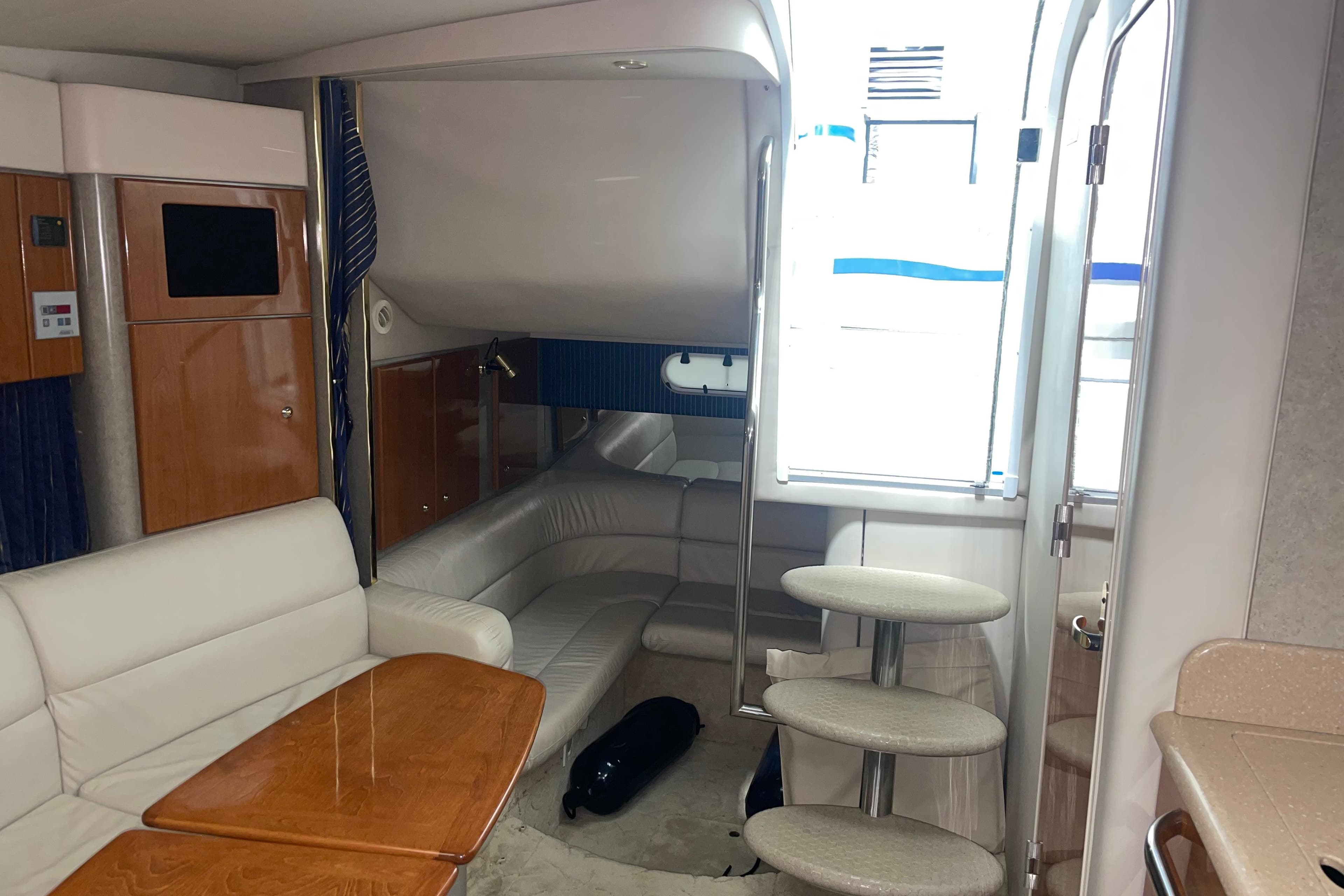 Interior of a 2004 Formula 34 Performance Cruiser with seating and wooden table.