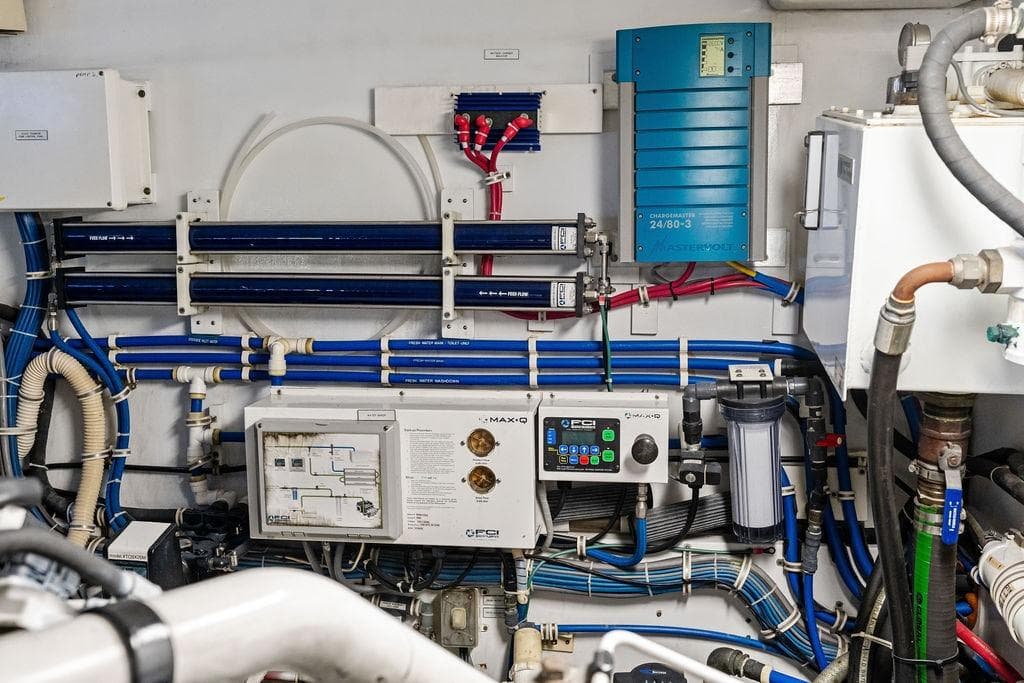 Engine room of 2006 Hatteras 68 Convertible yacht, showcasing complex wiring and control systems.