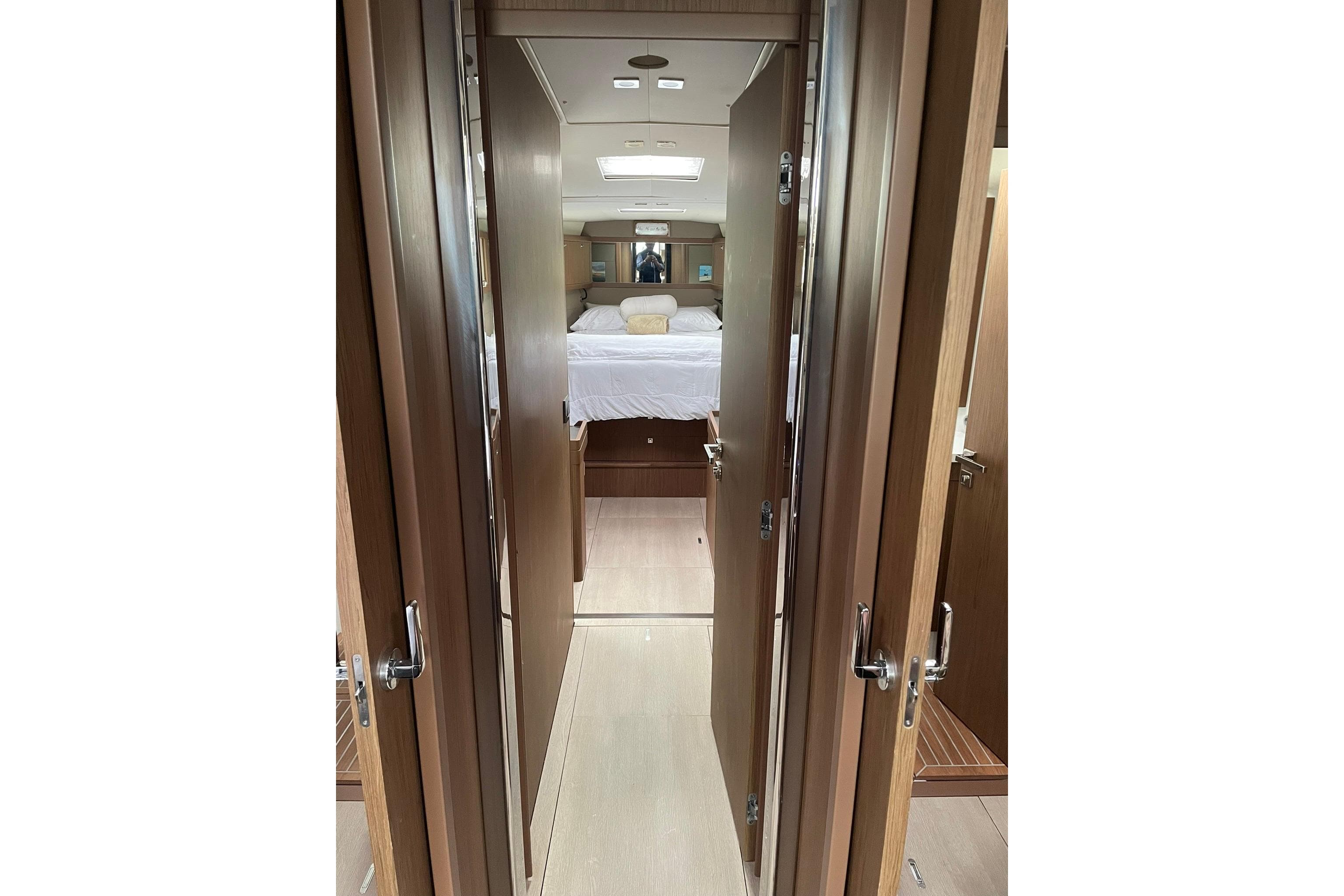 Interior view of 2017 Beneteau Sense 50 yacht cabin with wooden finishes.