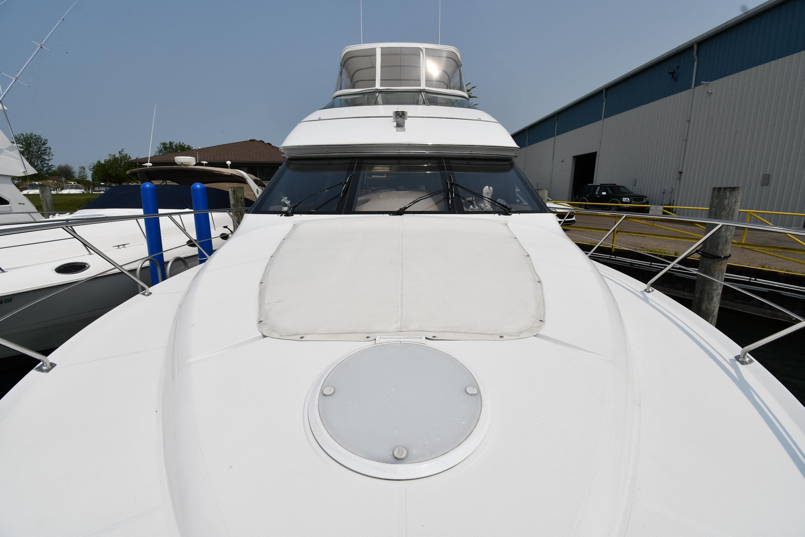 1998 Carver 530 Voyager Pilothouse yacht docked at marina, front view.