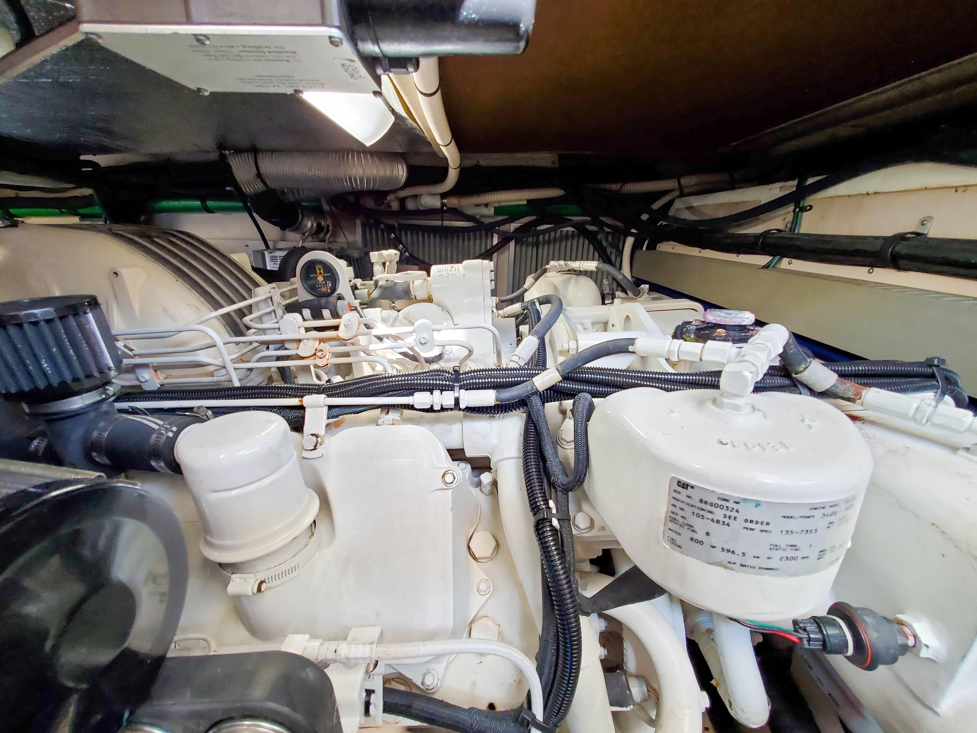 Engine room of a 1997 Sea Ray 580 Super Sun Sport yacht, showcasing mechanical components.