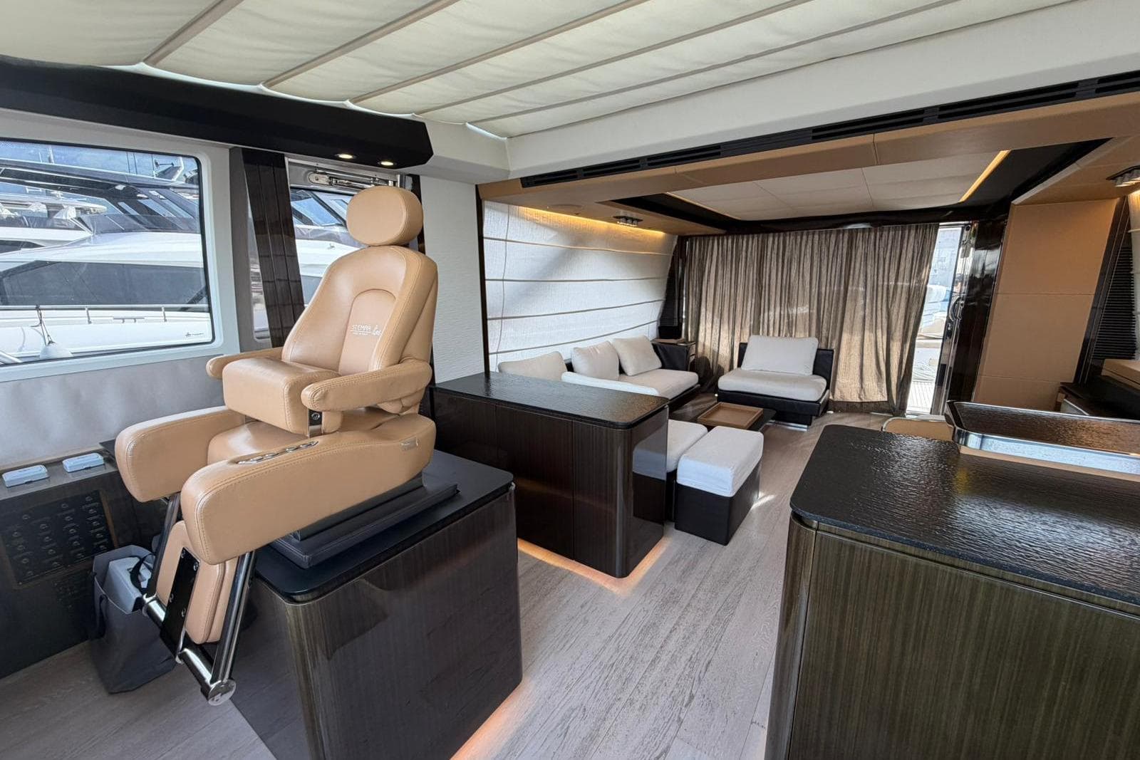 Luxurious interior of a 2016 Azimut 77S yacht with plush seating and modern design.