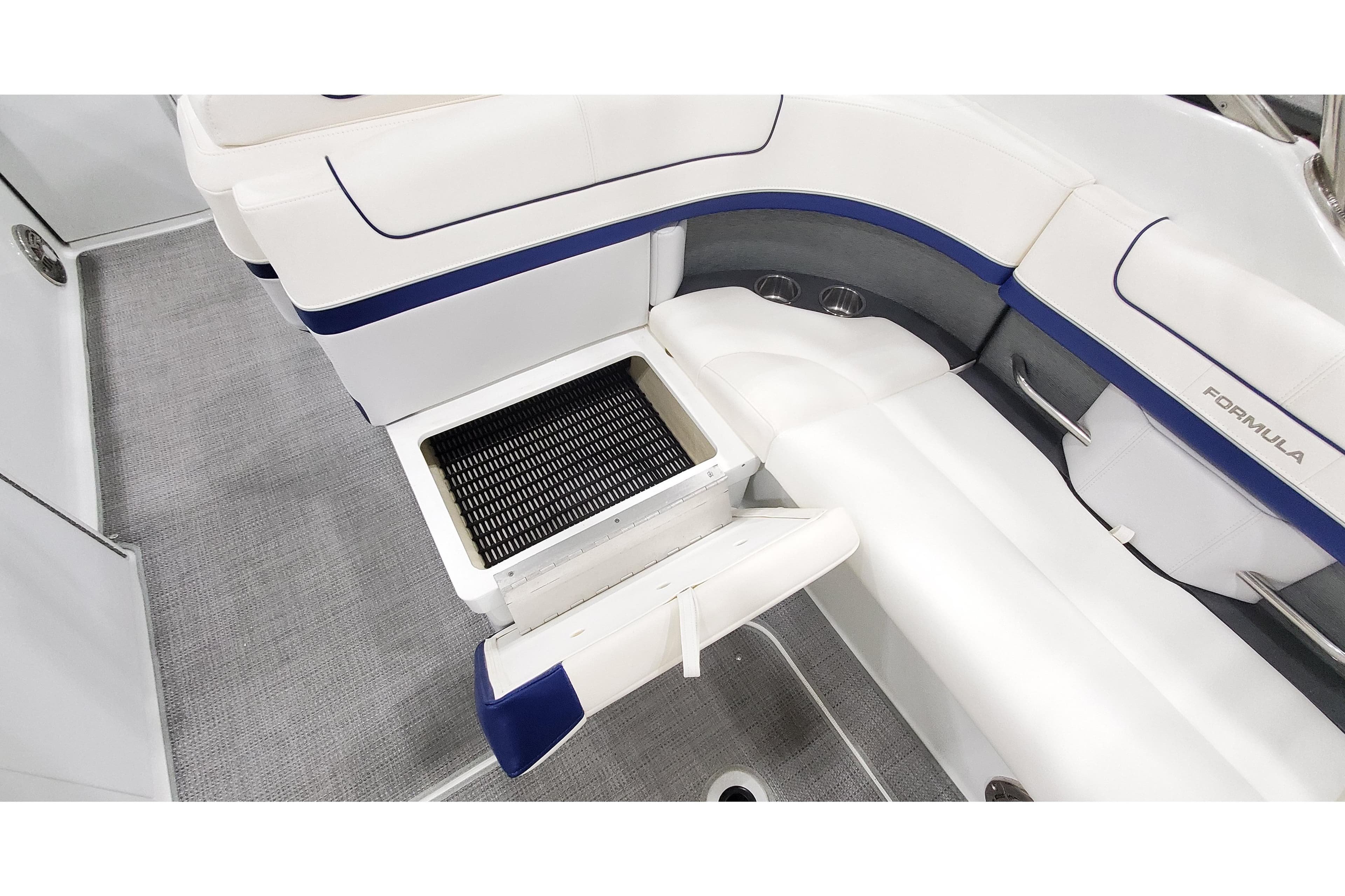 2013 Formula 310 Bowrider interior with white seating and storage compartment open.