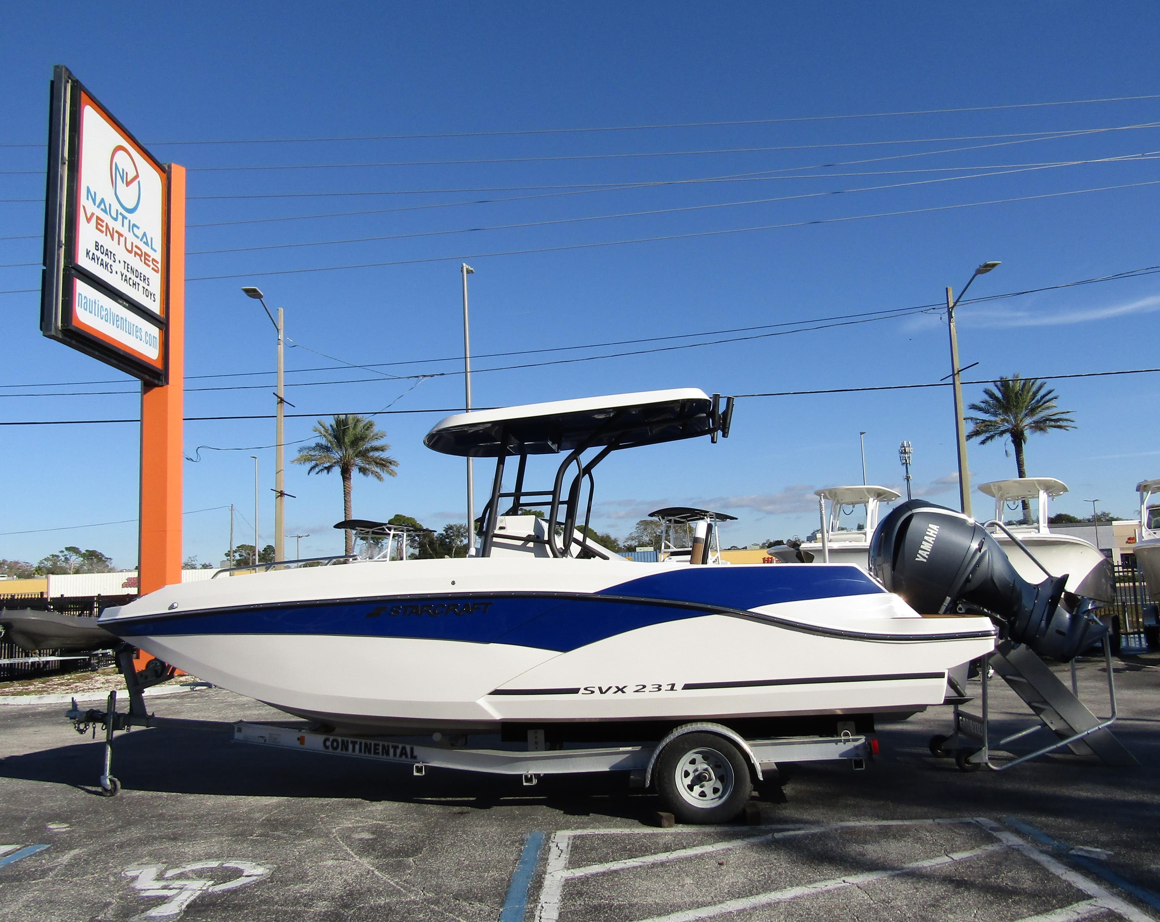 2024 Starcraft SVX 231 OB CC boat on trailer at dealership.