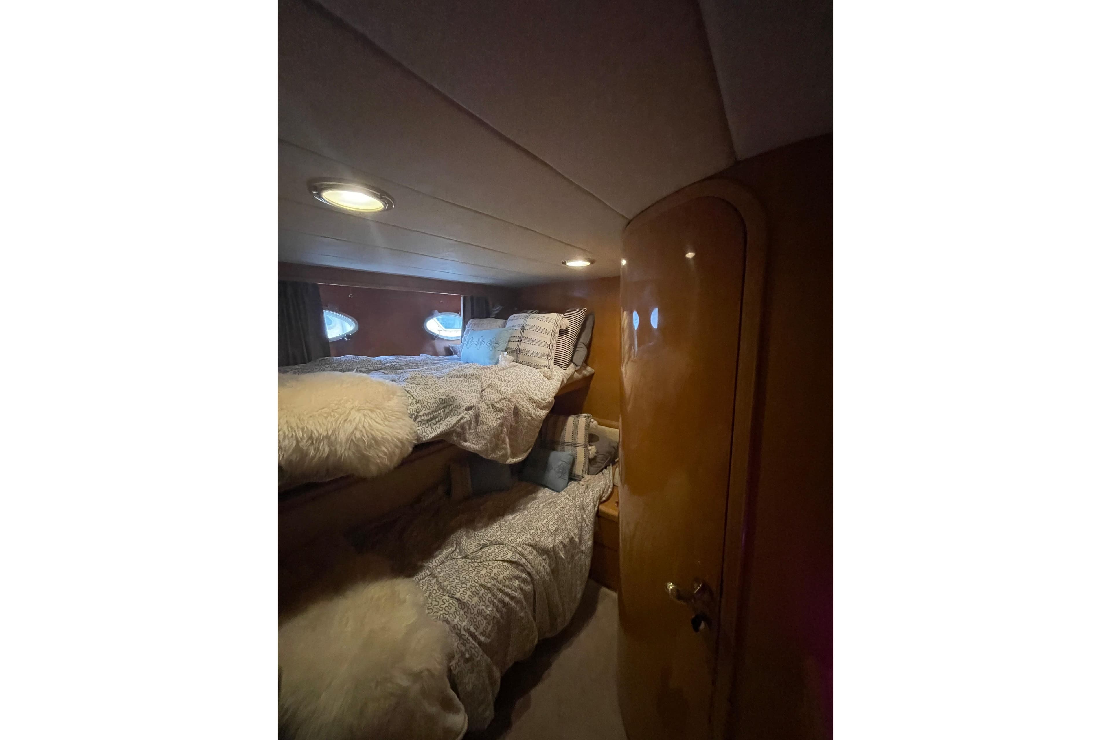 Cozy cabin interior with bunk beds in 1994 Johnson High-Tech 65 Euro yacht.