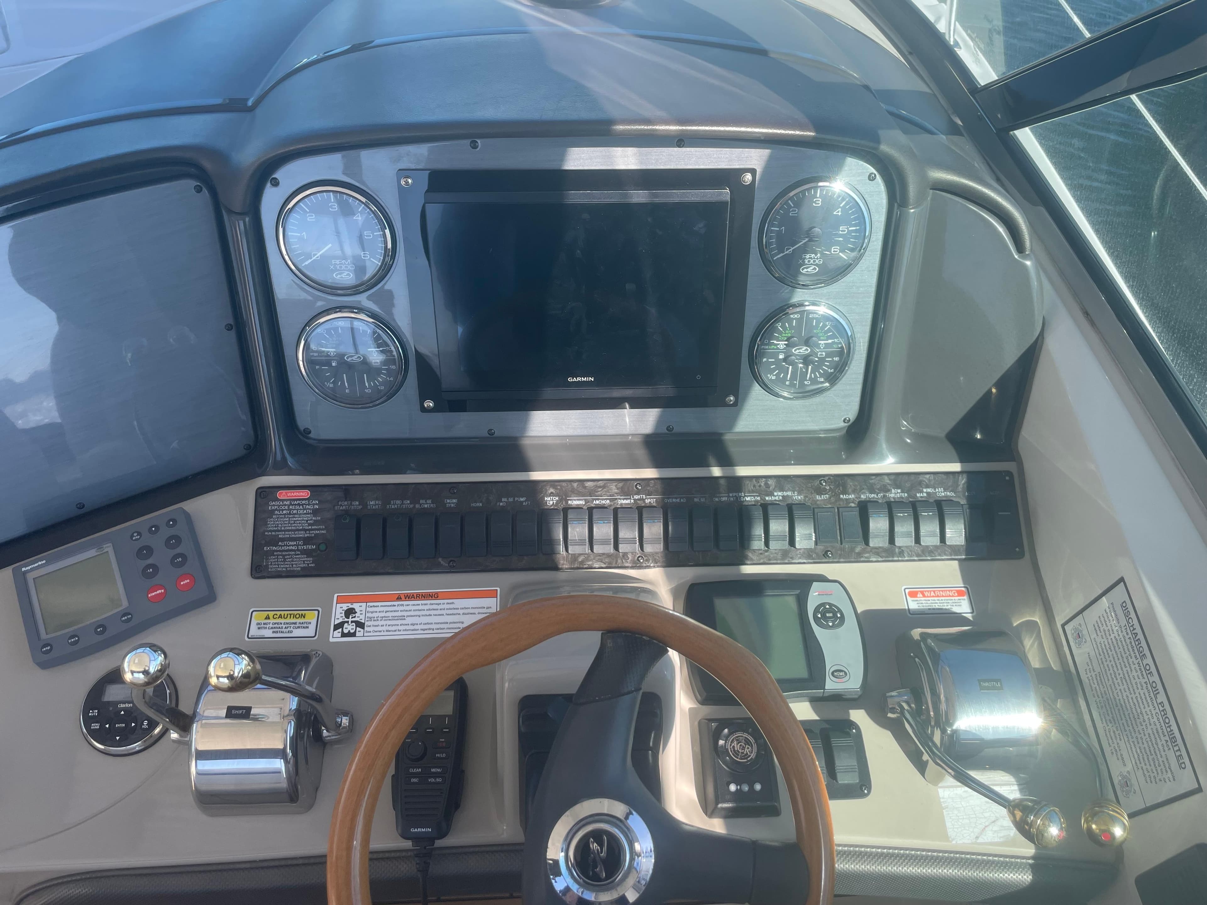 Control panel of a 2006 Sea Ray 380 Sundancer boat with gauges and navigation equipment.