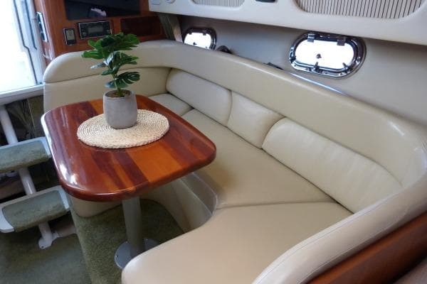 2004 Four Winns 298 Vista interior with cream leather seating and wooden table.