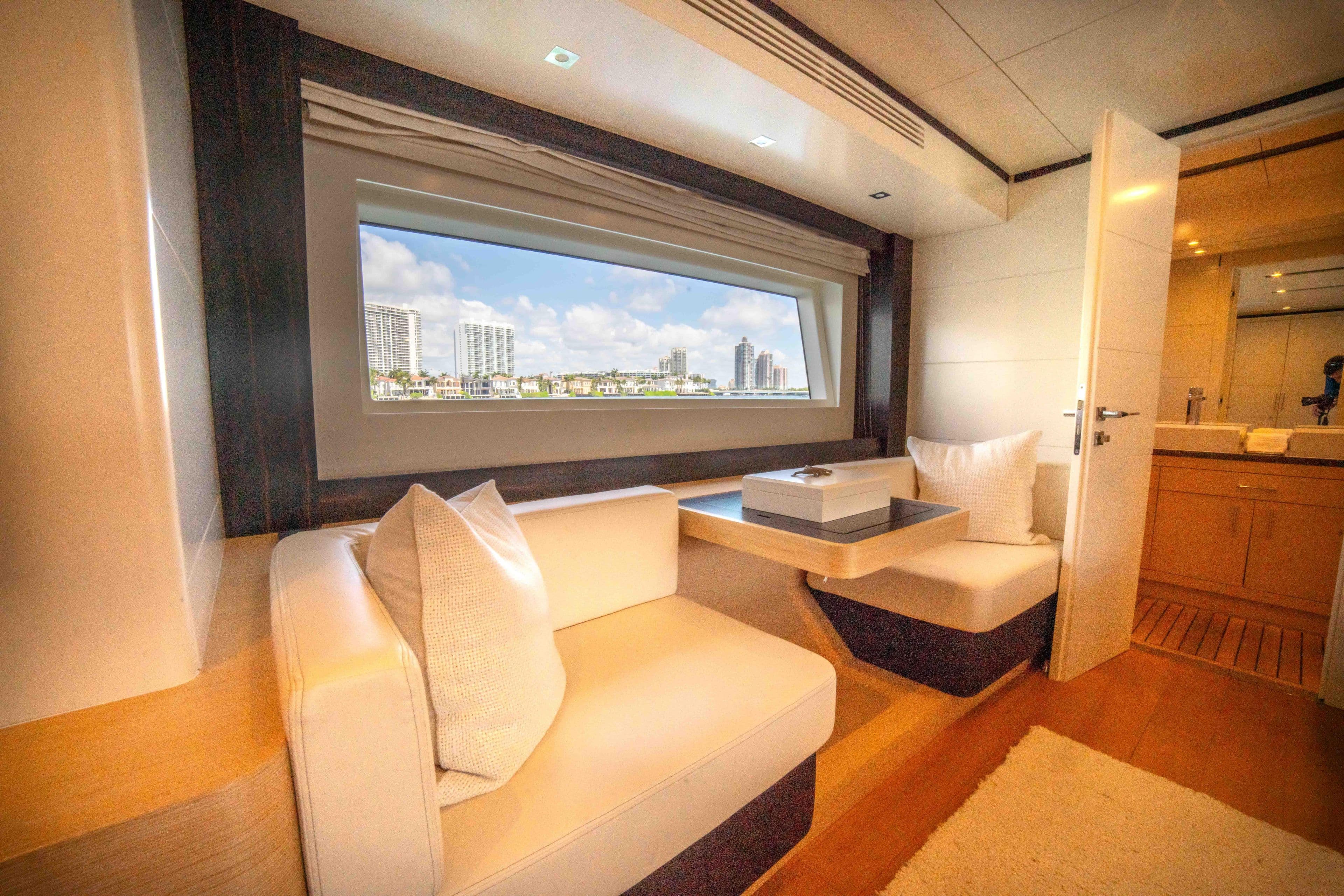 Luxurious interior of 2018 Sirena 64 yacht with cityscape view through window.