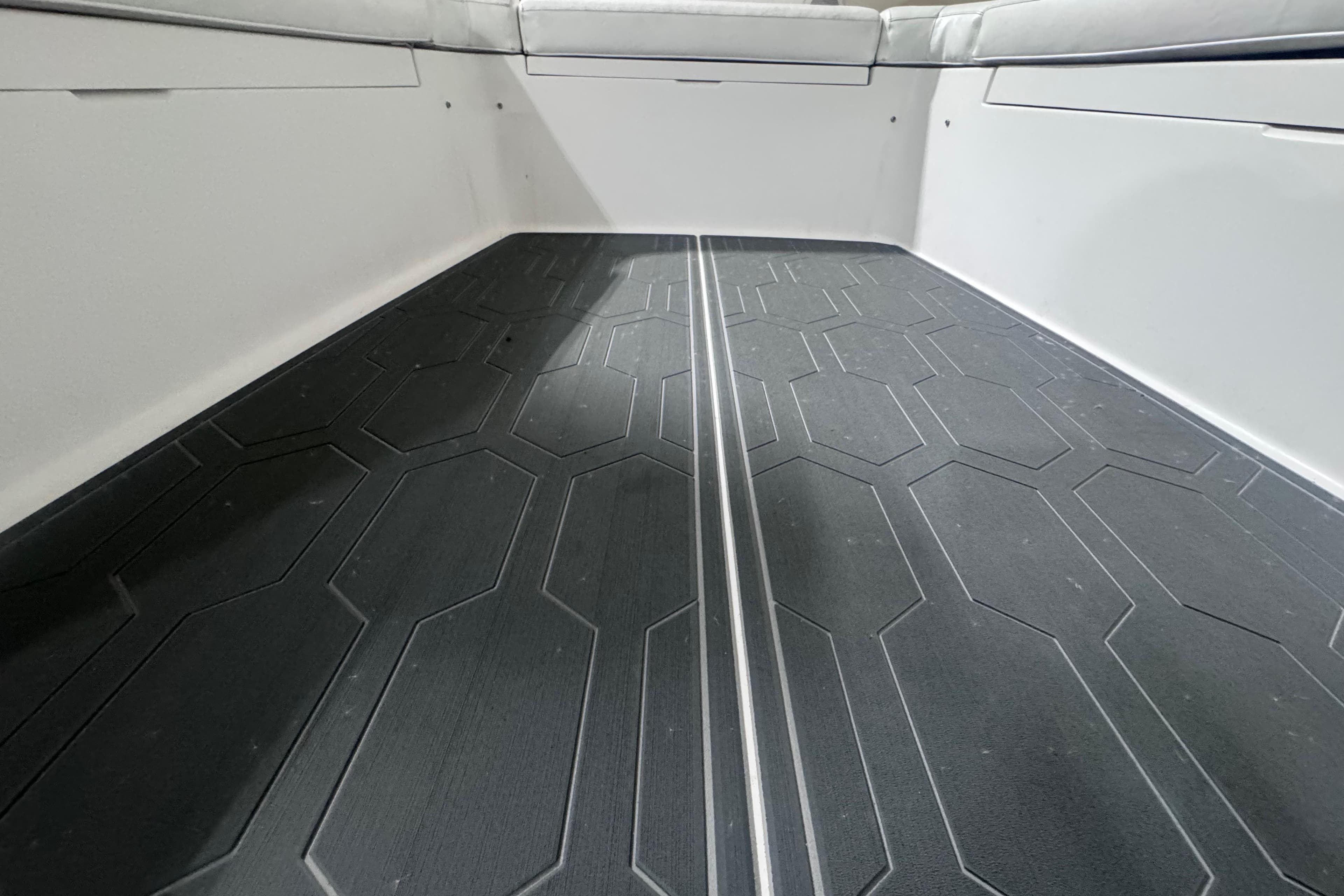 2010 Regulator 34SS boat interior with textured flooring and cushioned seating.