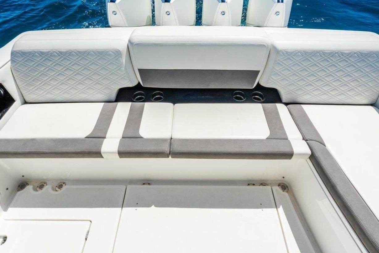 Luxury seating on 2019 Cigarette 41' GTR boat, featuring elegant upholstery and cup holders.