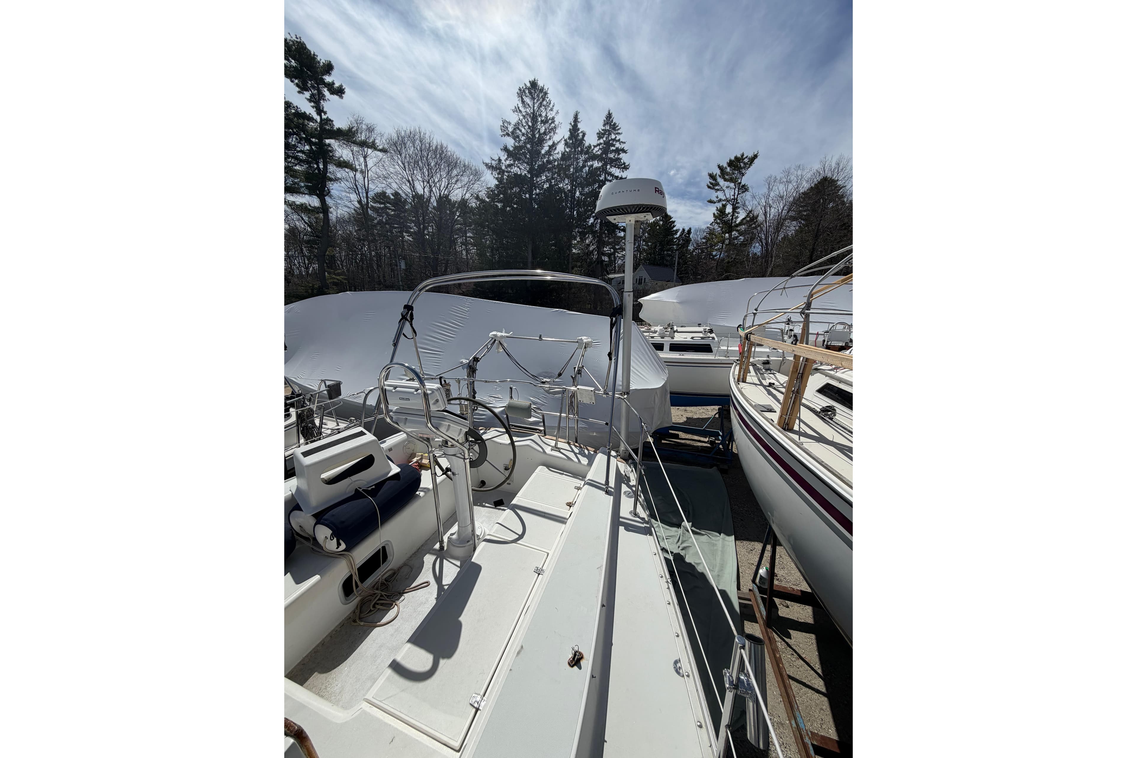 1989 Freedom 38 Sloop sailboat docked, featuring a spacious deck and steering wheel.