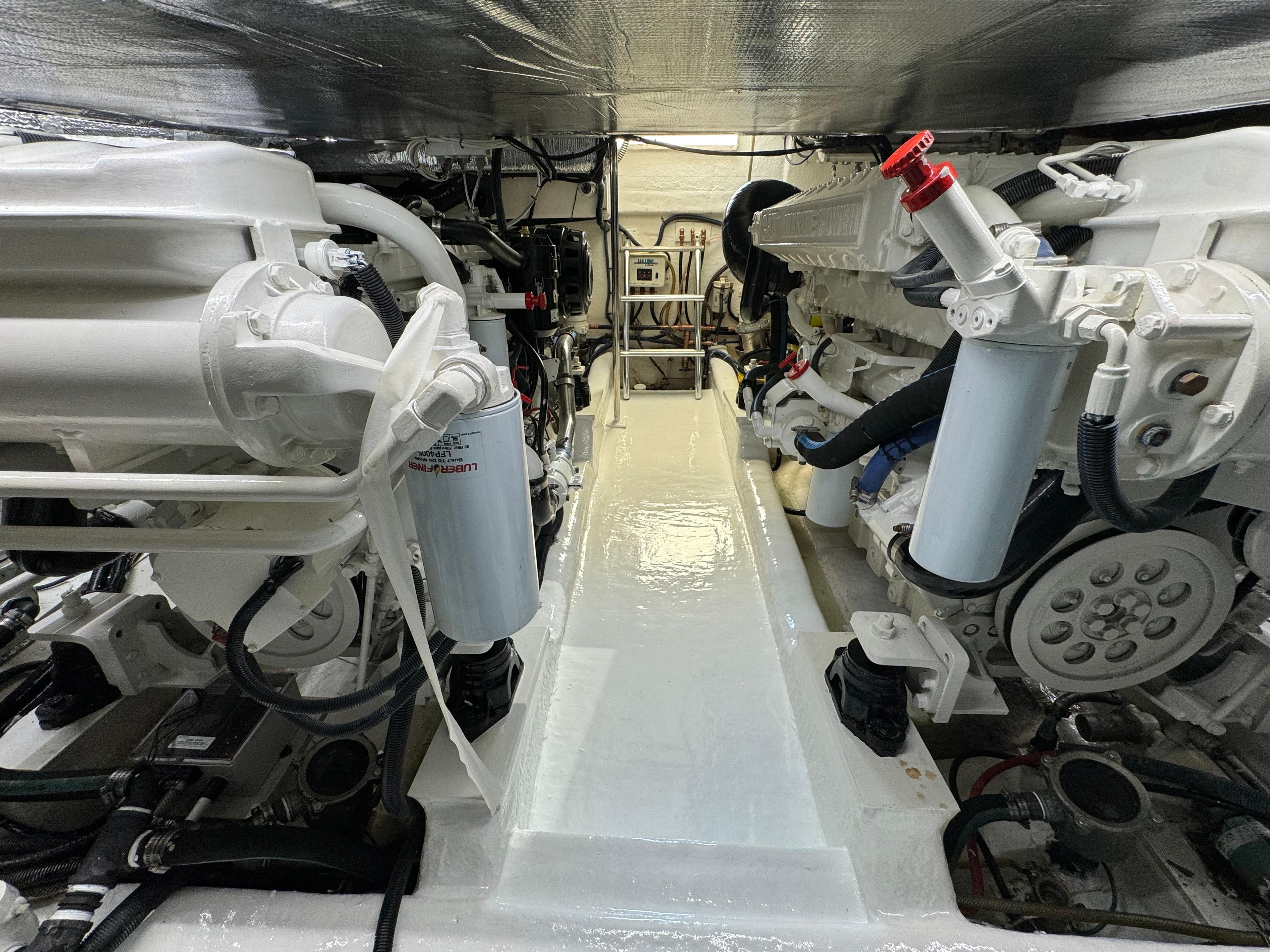 Engine room of 2003 Riviera 48 yacht, showcasing mechanical components and systems.