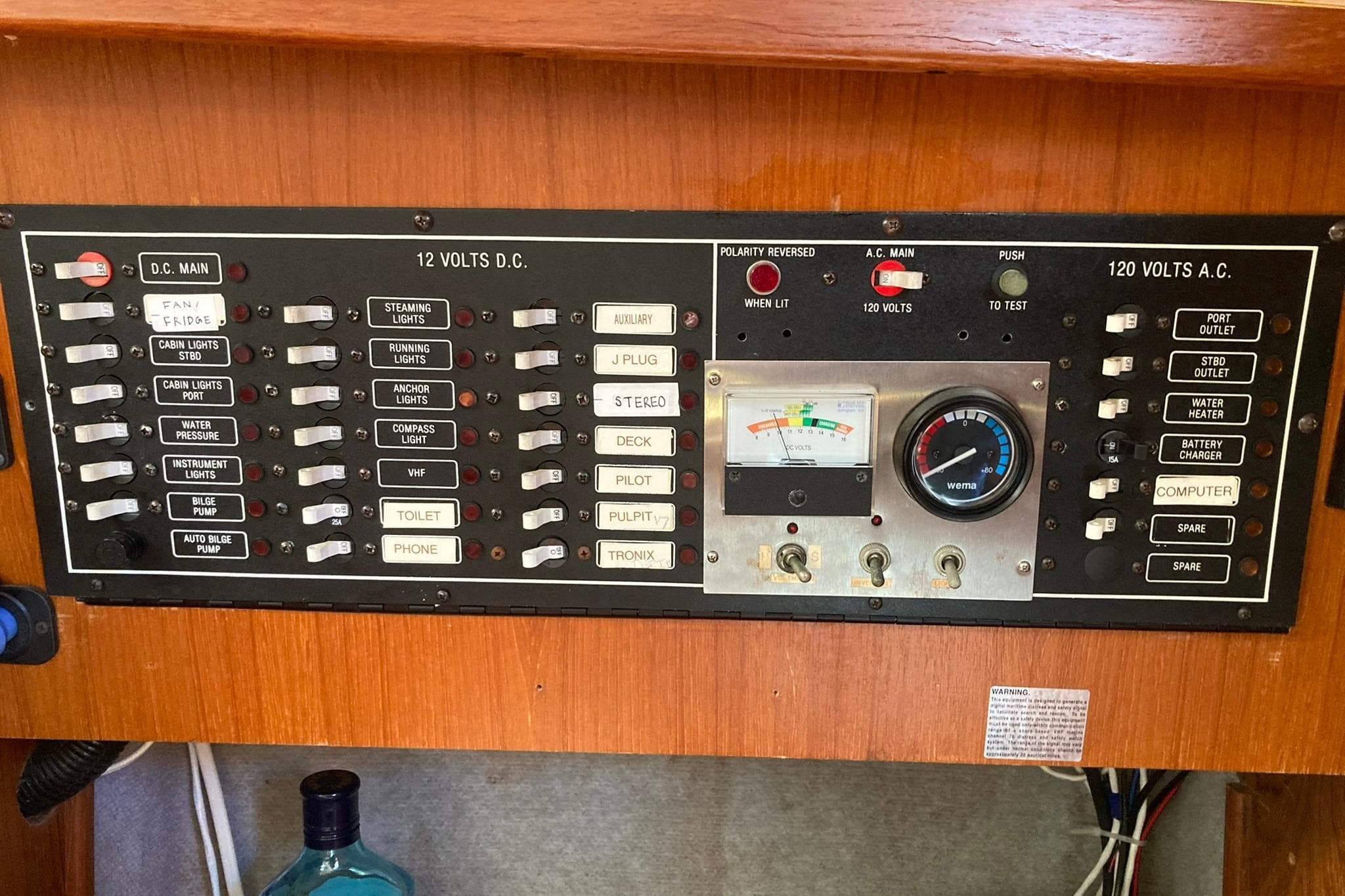 Electrical control panel of a 1987 Hunter Legend 35 sailboat, featuring switches and gauges.