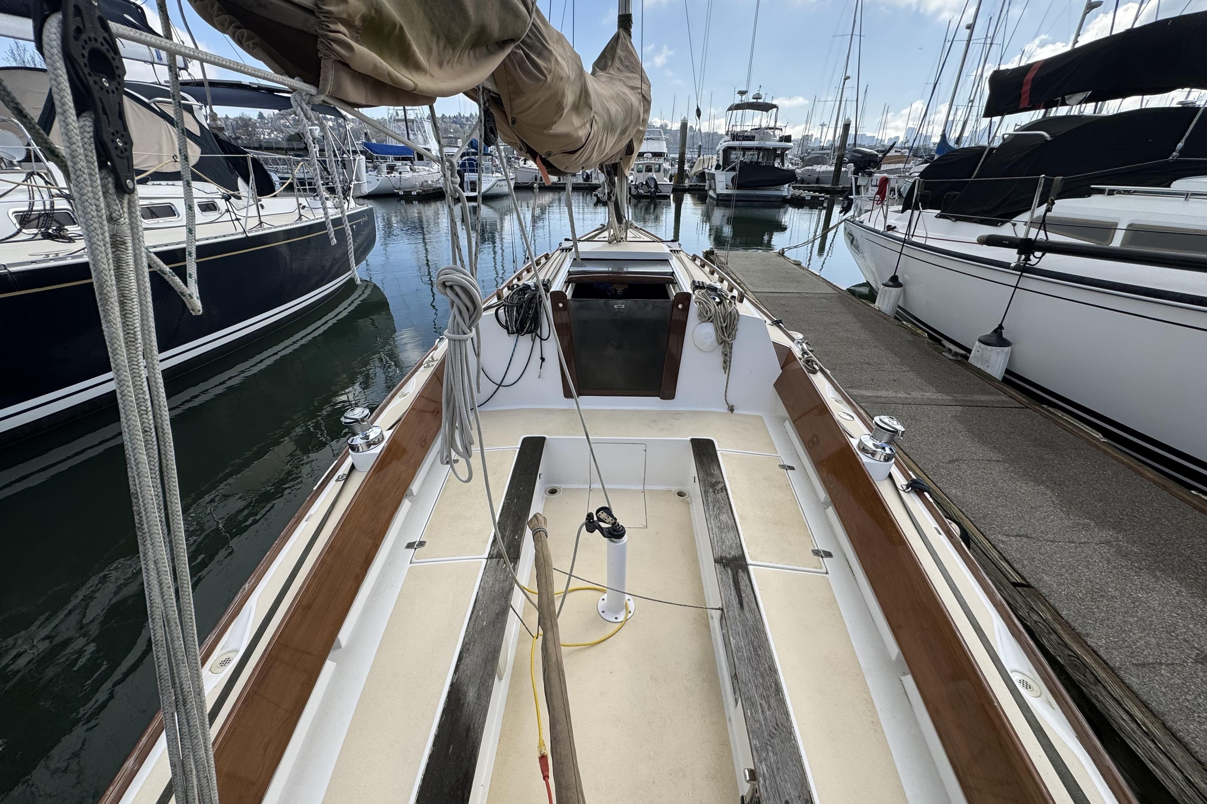 2017 Alerion Express 28 sailboat docked at marina, surrounded by other boats.