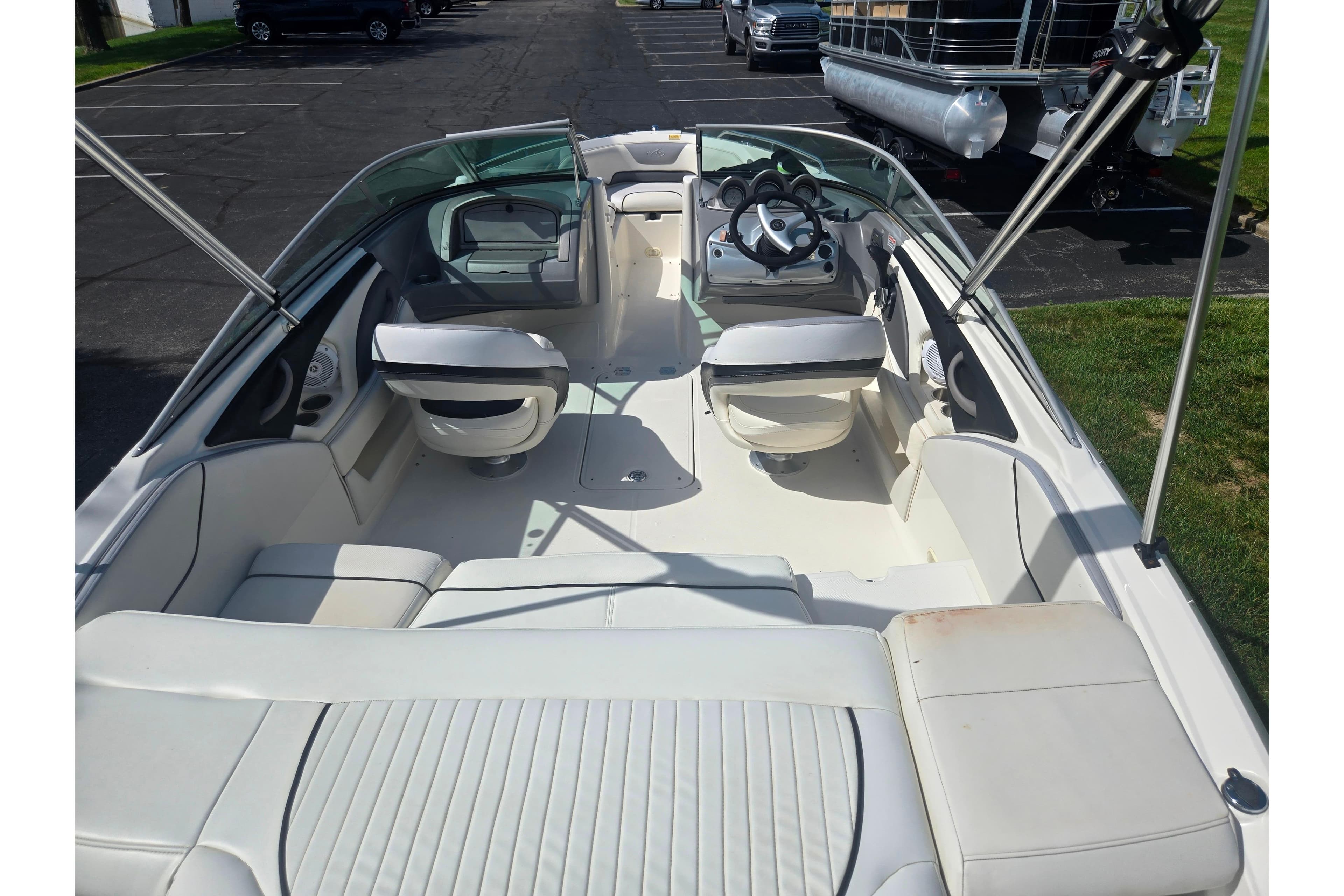 2006 Monterey 194FS Montura boat interior with white seating and steering wheel.
