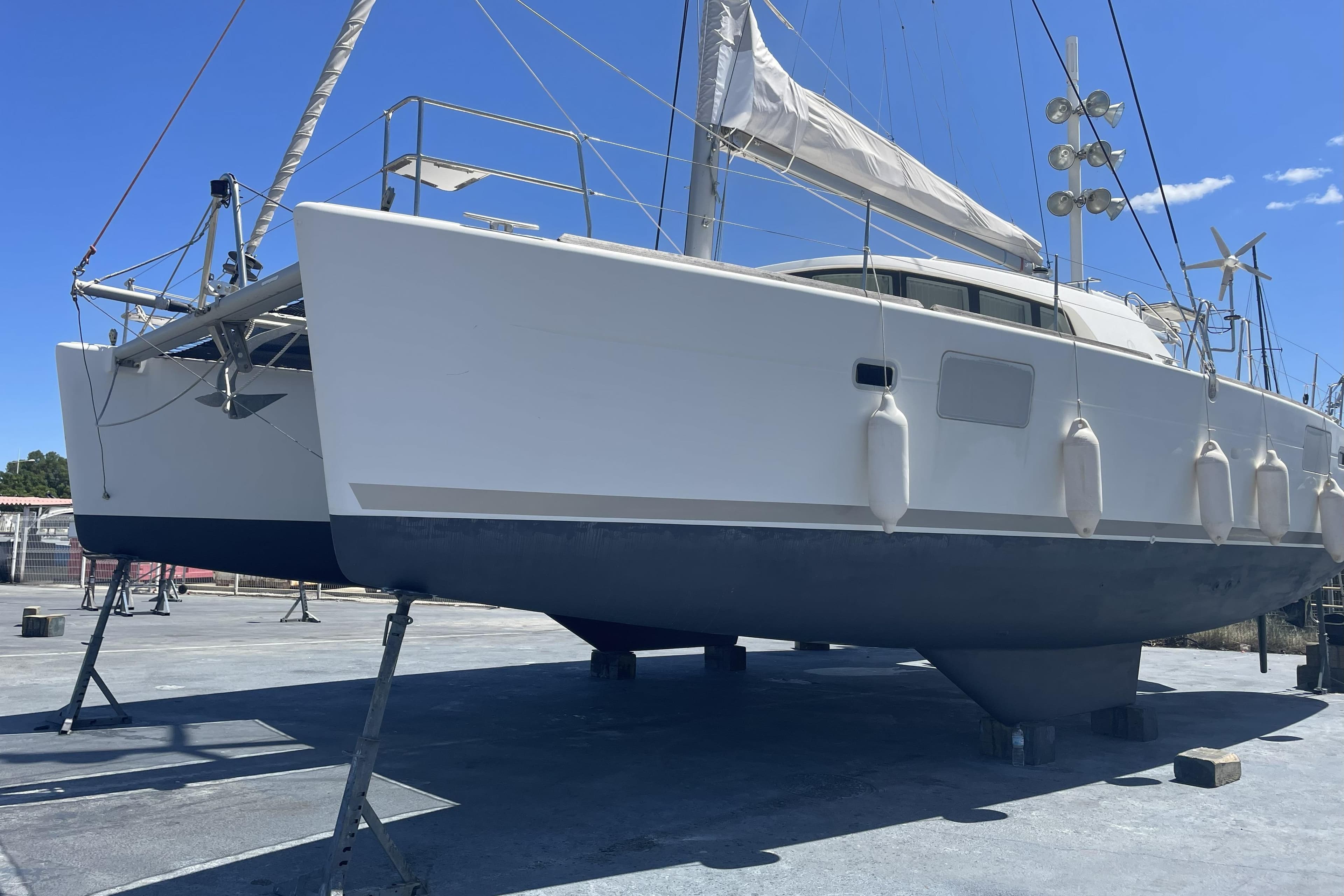 2008 Lagoon 440 catamaran on dry dock, showcasing its dual hull design and rigging.