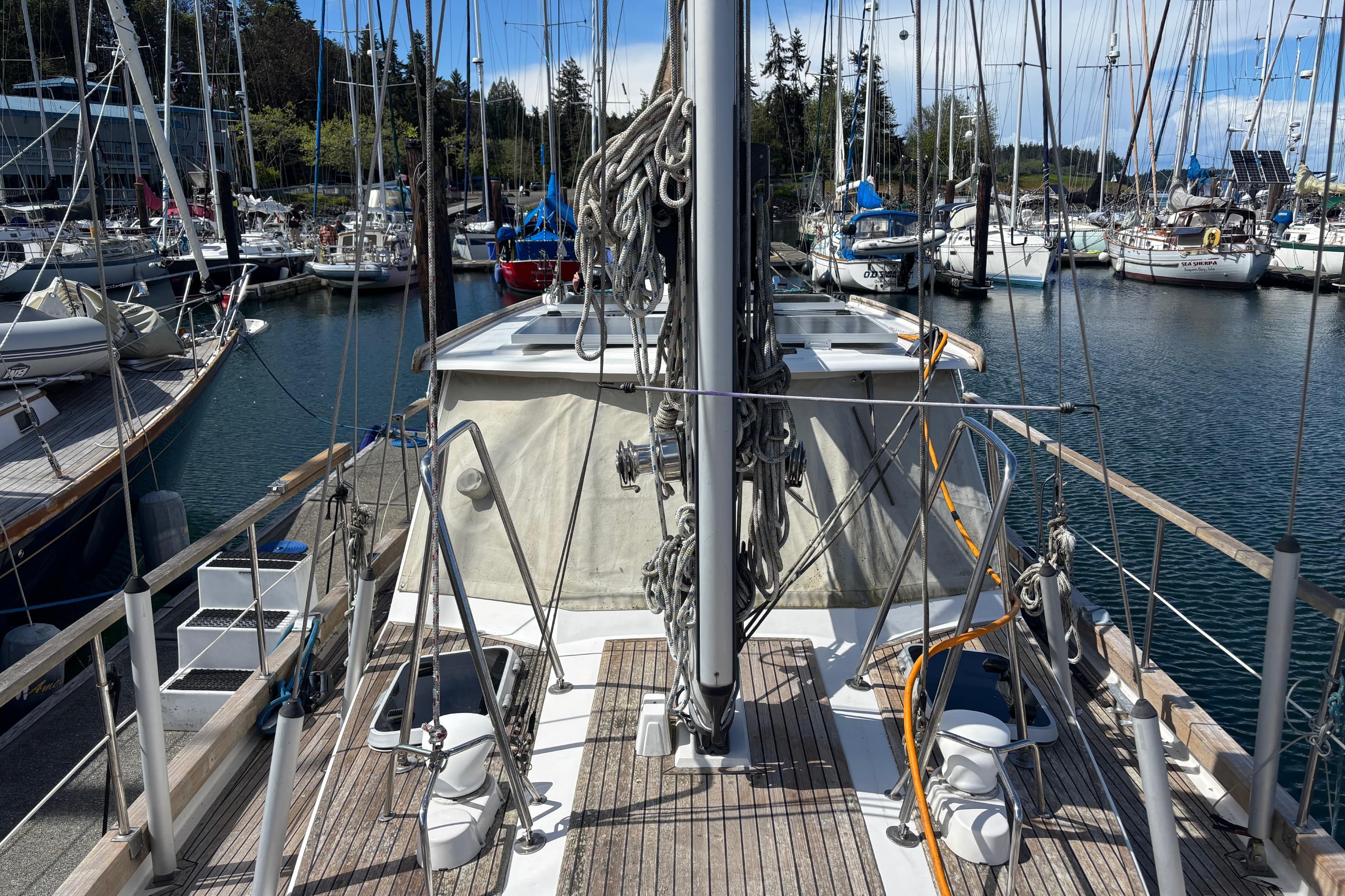 2001 Nauticat Ketch sailboat docked in a marina, surrounded by other boats.