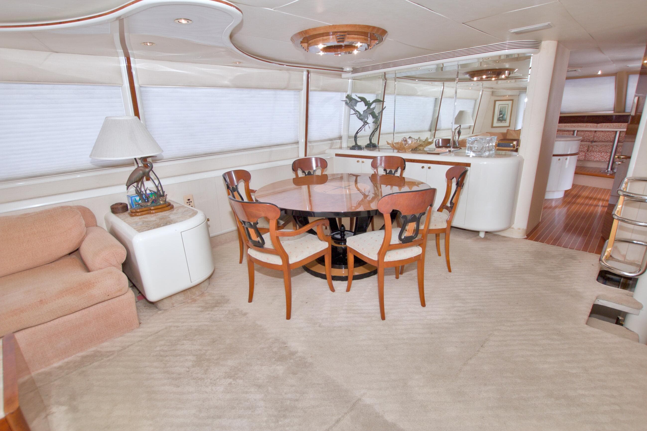 Luxurious interior of 1998 Lazzara 76 Skylounge Grand Salon yacht with elegant dining area.