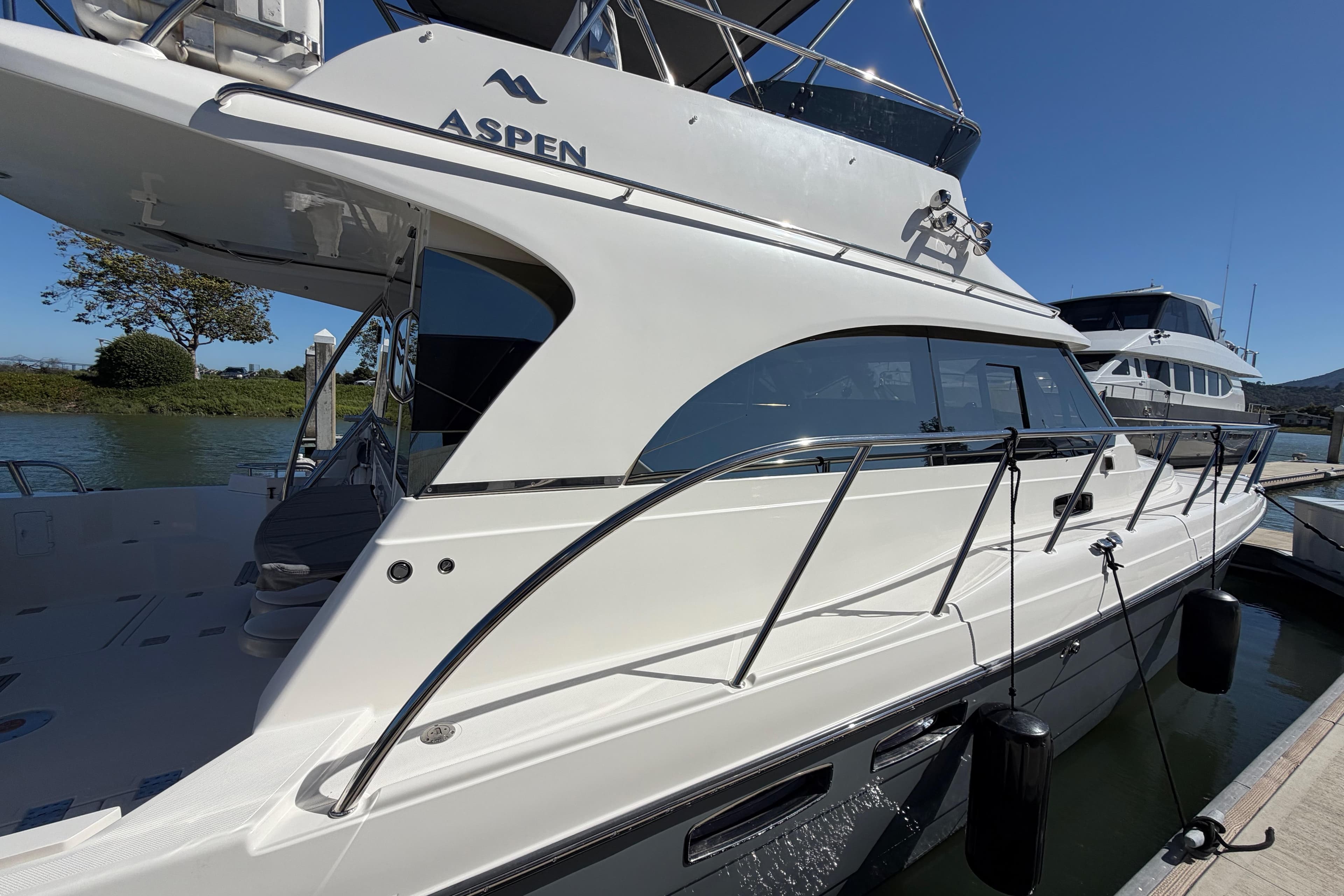 2017 Aspen C120 yacht docked, showcasing sleek design and modern features under clear blue sky.