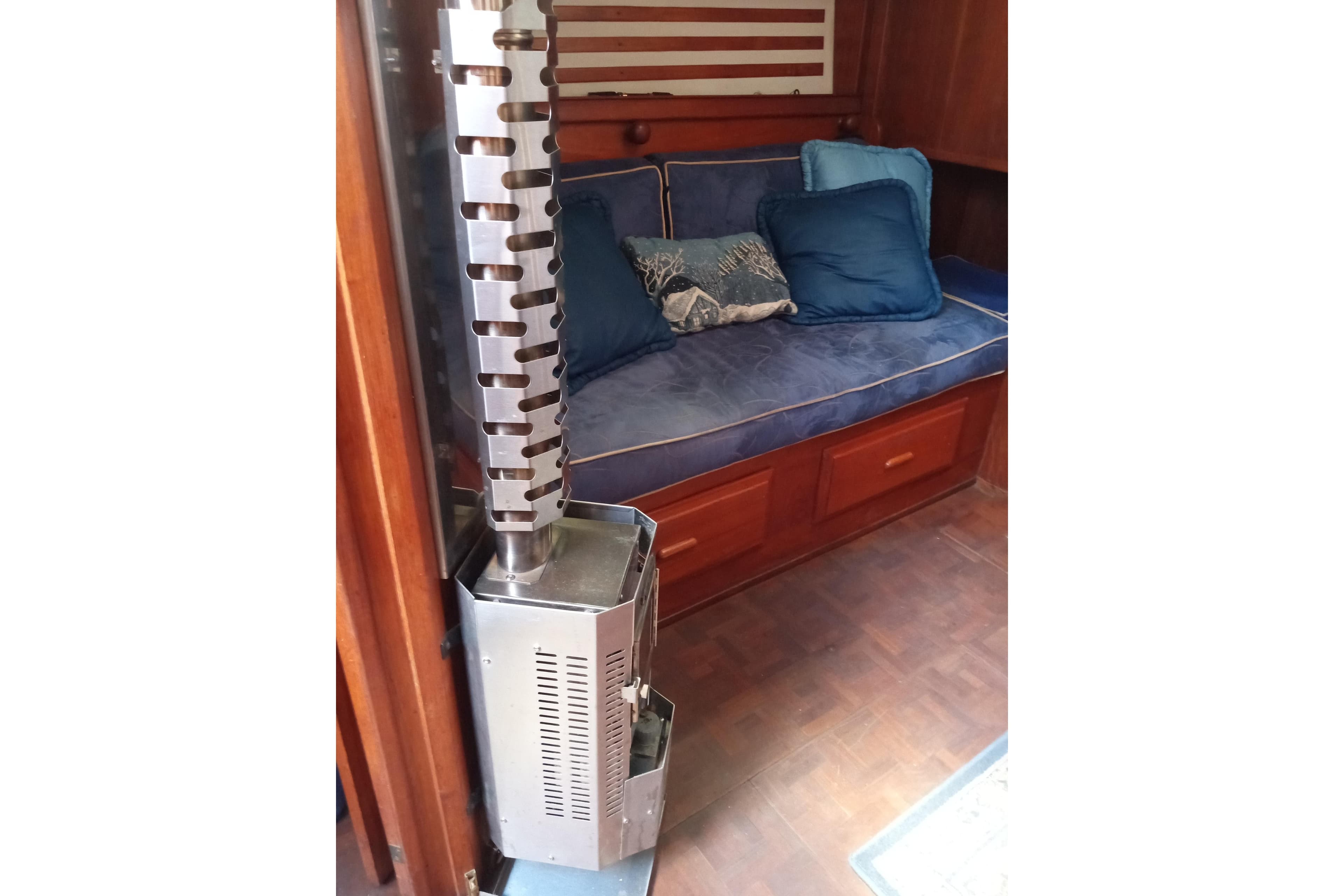 Cozy interior of 1982 ENDEAVOR E37 with heater and blue-cushioned seating.