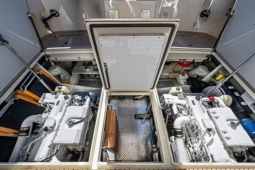 Engine room of 2013 Mikelson Luxury Sportfisher showcasing dual engines and mechanical components.