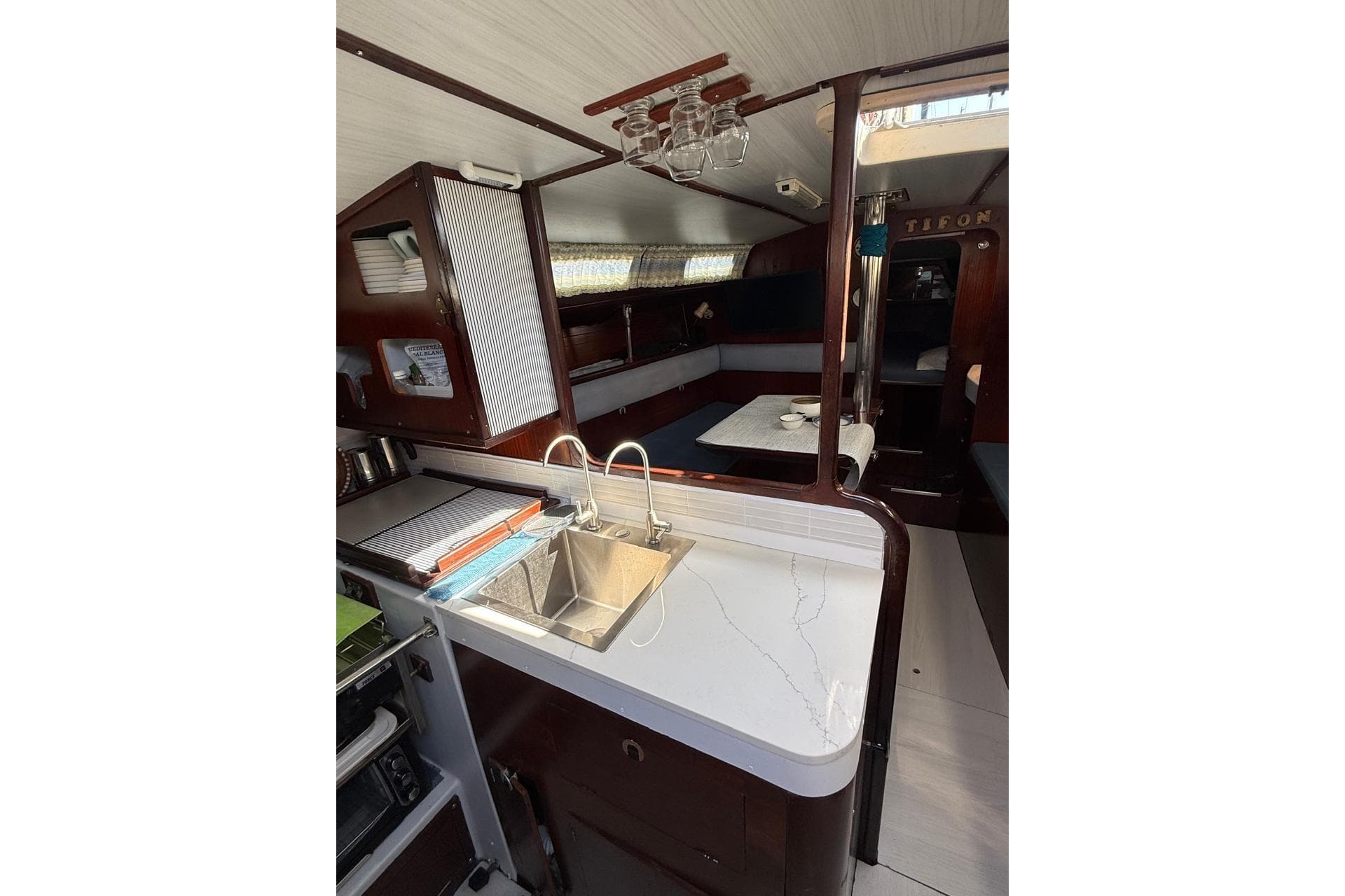 Interior of 1982 Dufour 4800 yacht with kitchen and seating area.