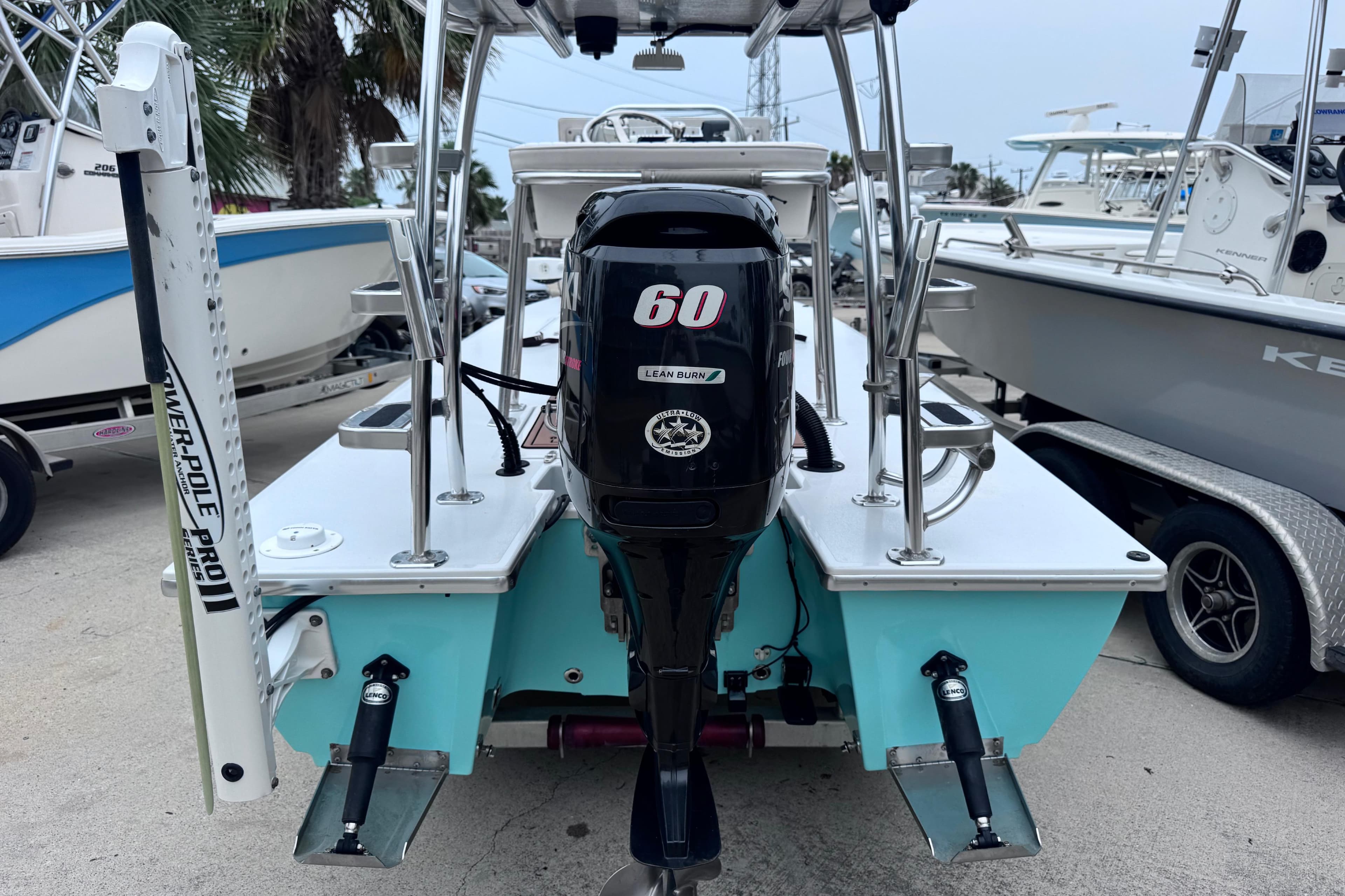 2016 East Cape Fury boat with 60 HP engine, docked among other boats.