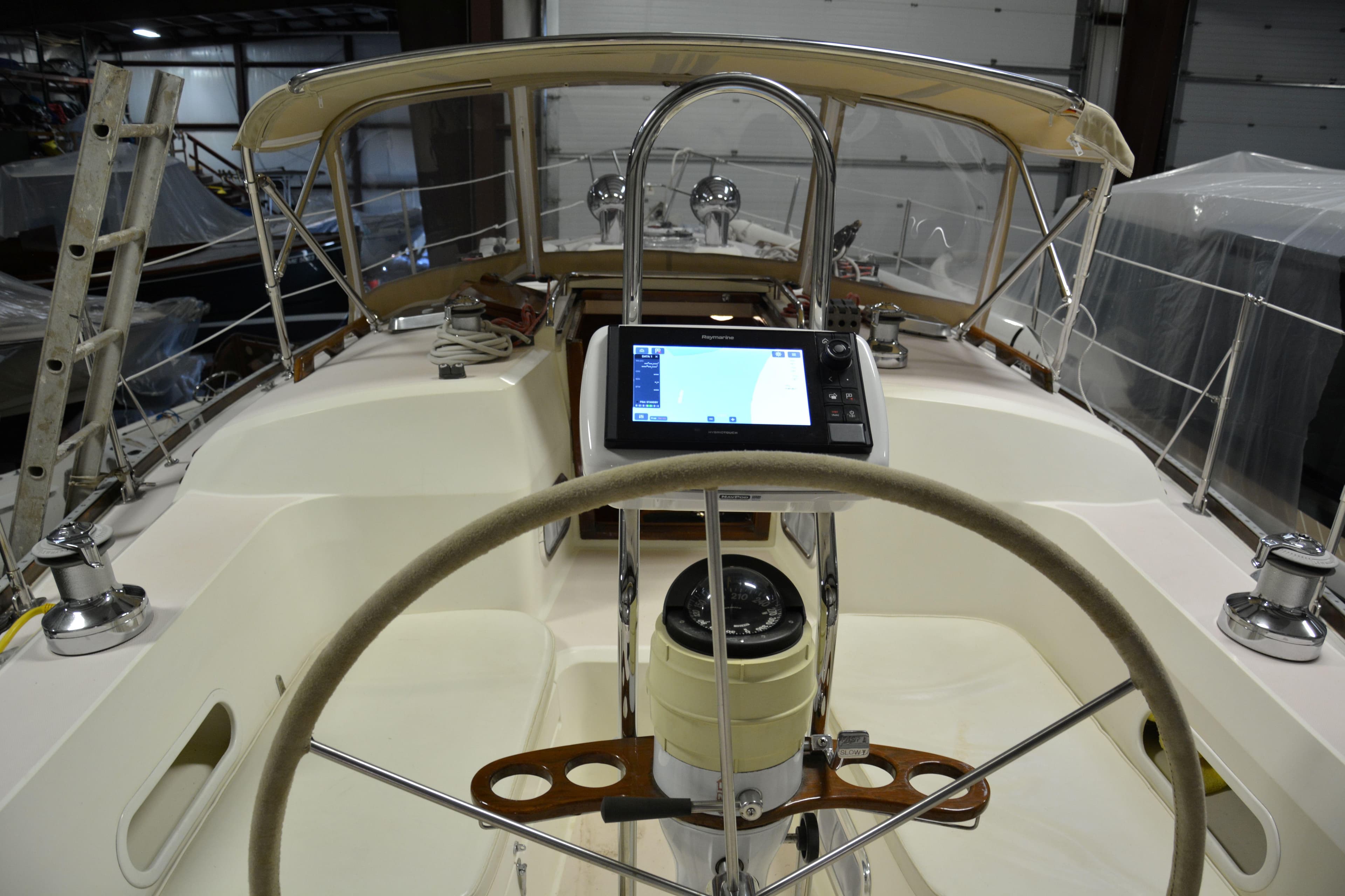 Cockpit of a 1995 Sabre 36 sailboat with navigation equipment and steering wheel.