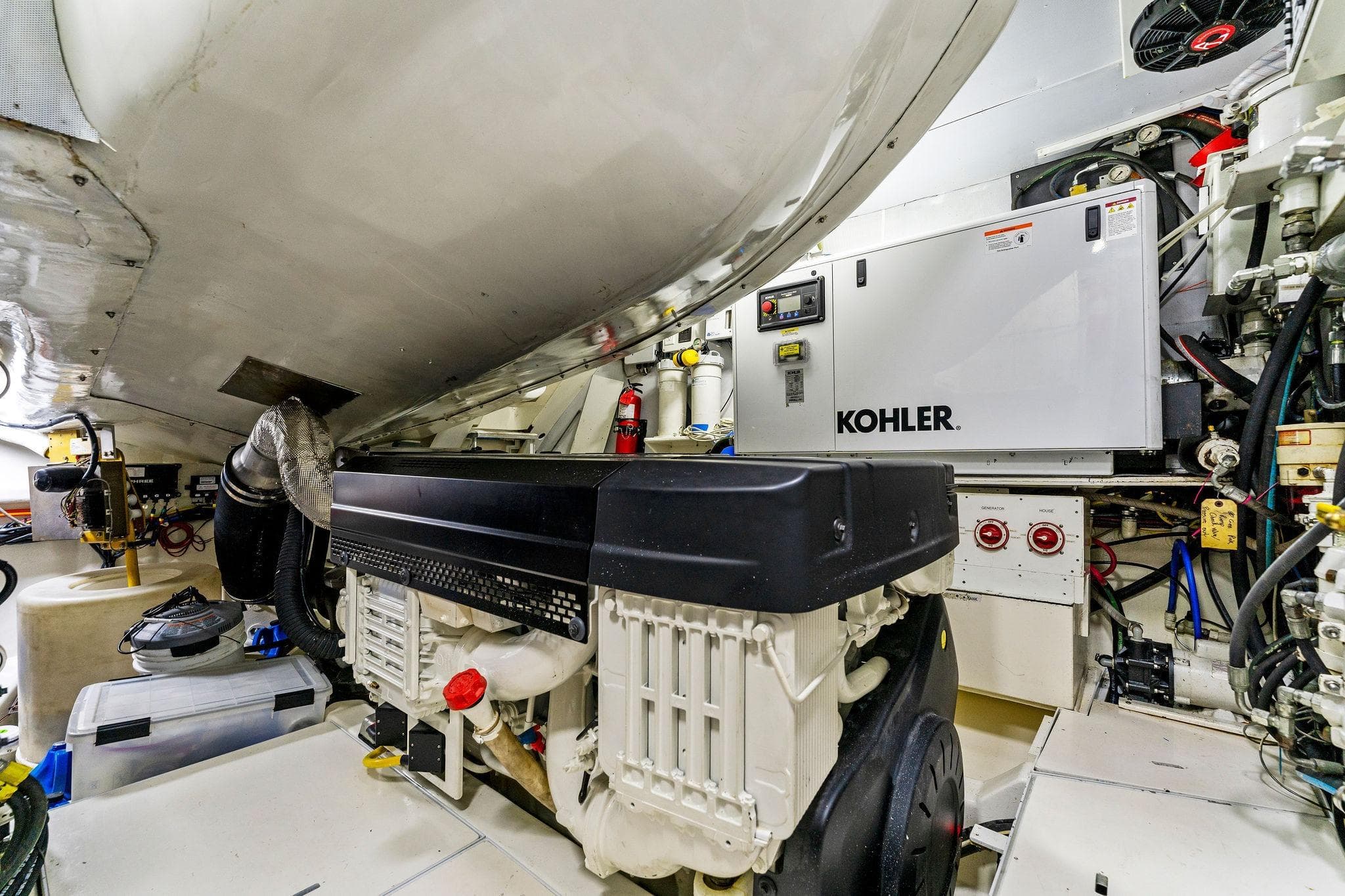 Engine room of a 2014 Lazzara 64 yacht featuring a Kohler generator.