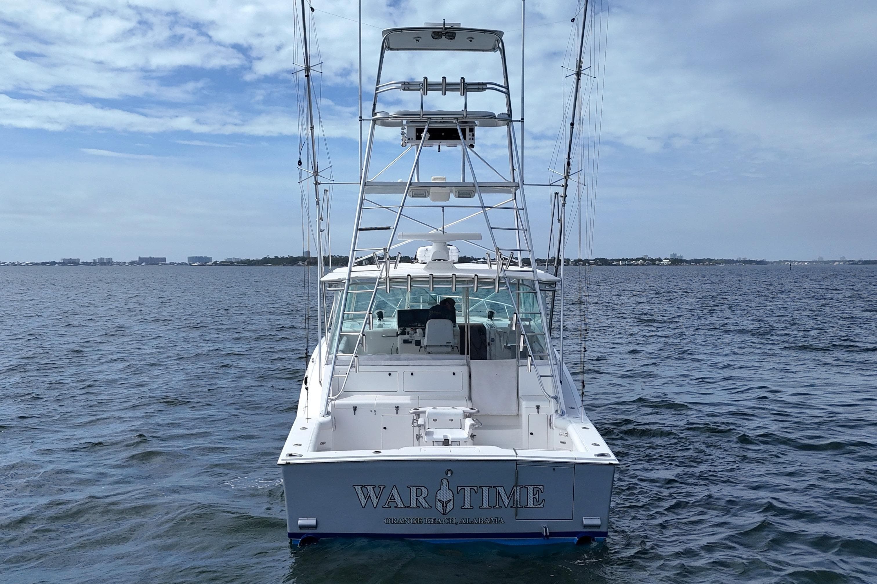 1998 Cabo 45 Express boat on open water, rear view with fishing tower.