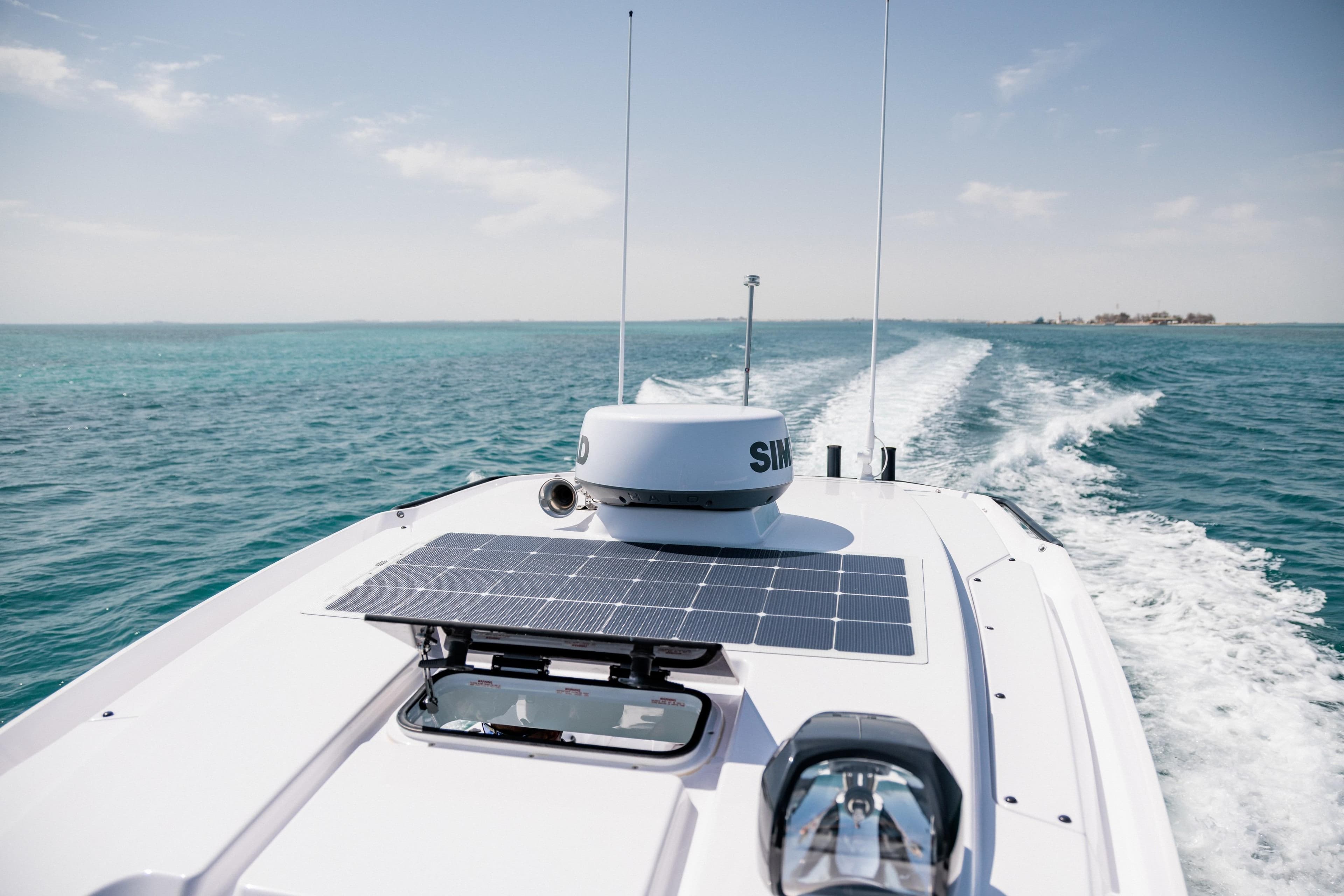 2026 Axopar 29 CCX boat cruising on clear blue ocean waters.