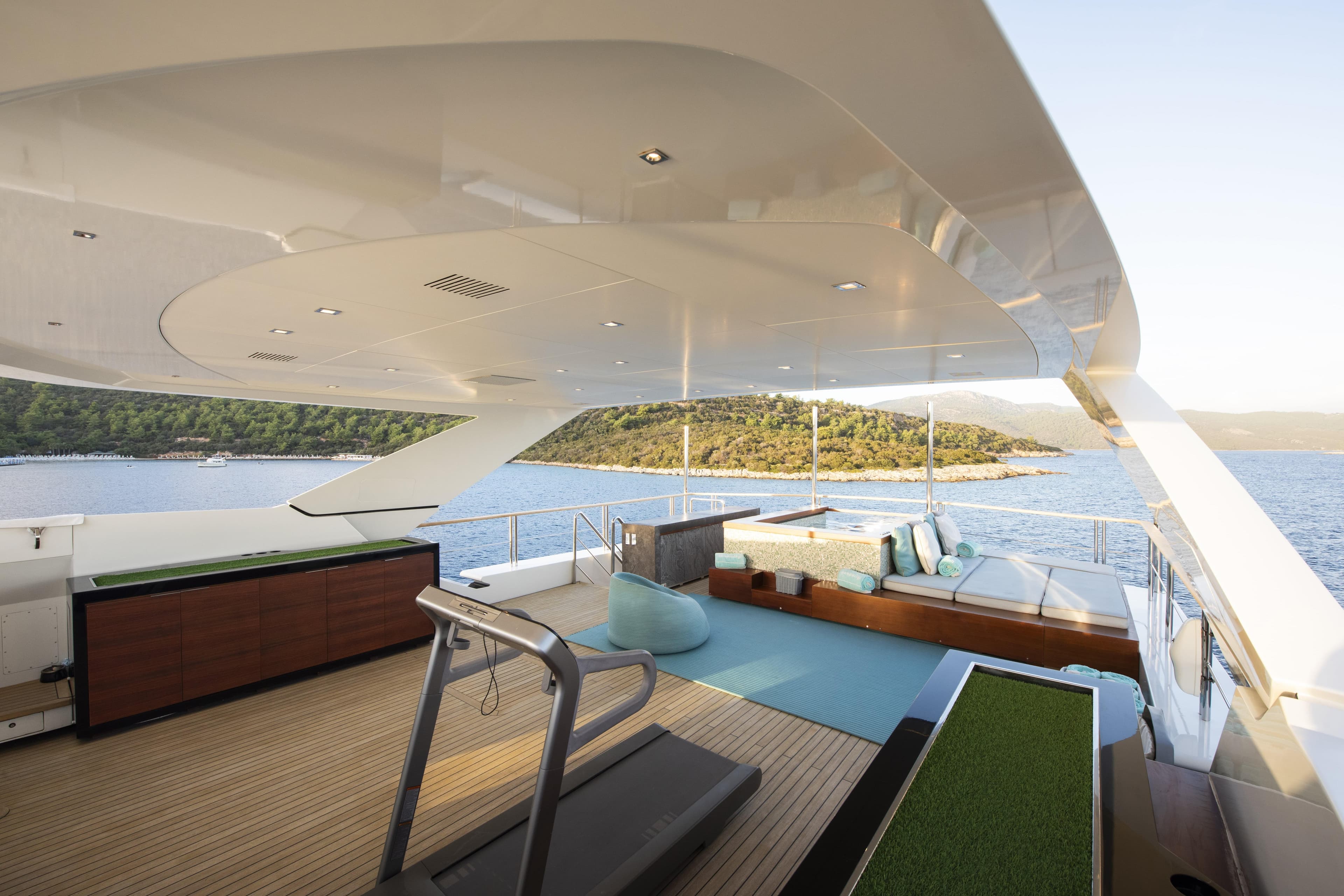 Luxurious Mondomarine SF40 yacht deck with modern seating, treadmill, and ocean view, 2015 model.