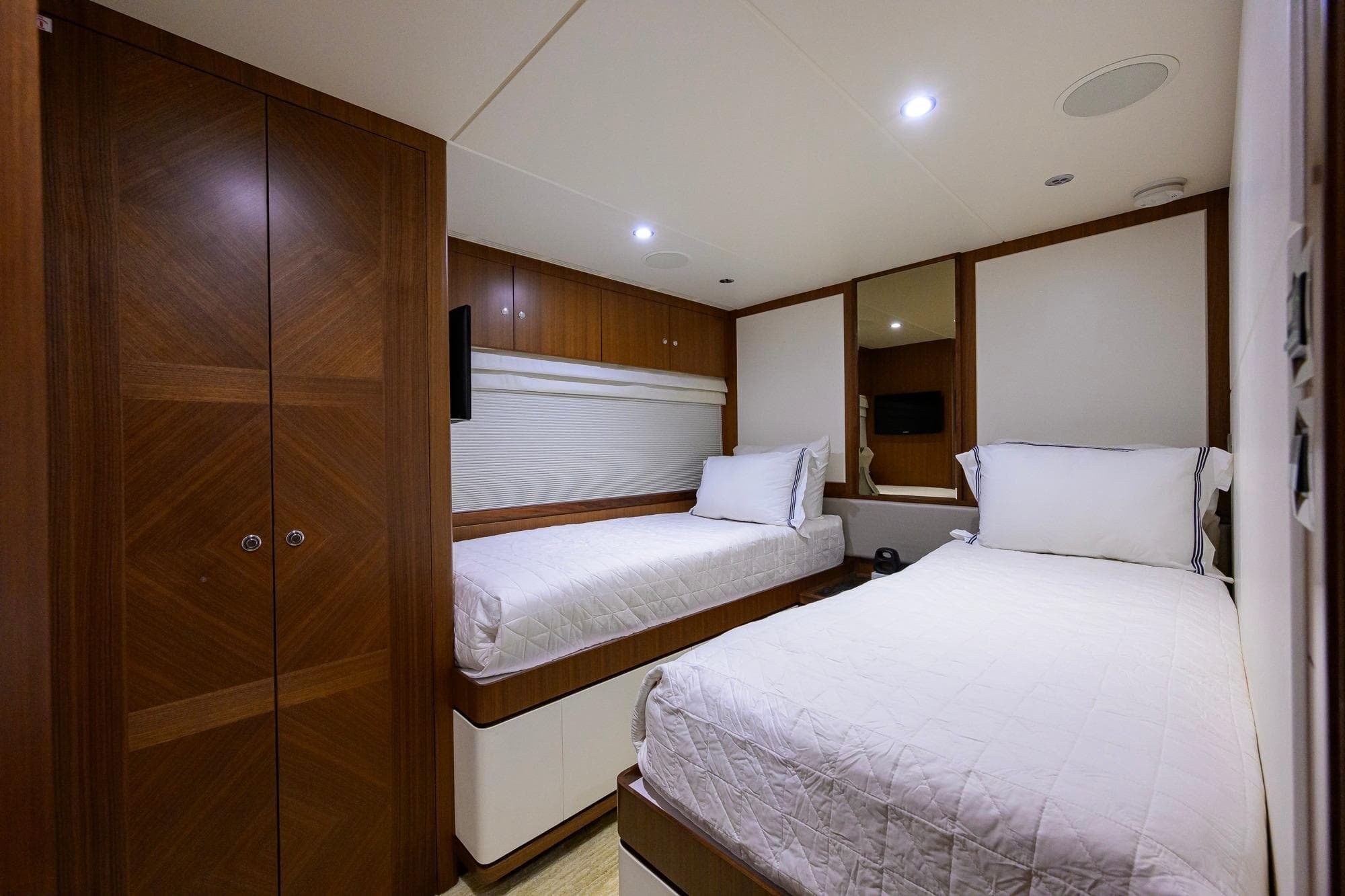 Luxurious twin cabin on 2017 Ocean Alexander 100 Motoryacht with elegant wood finishes.