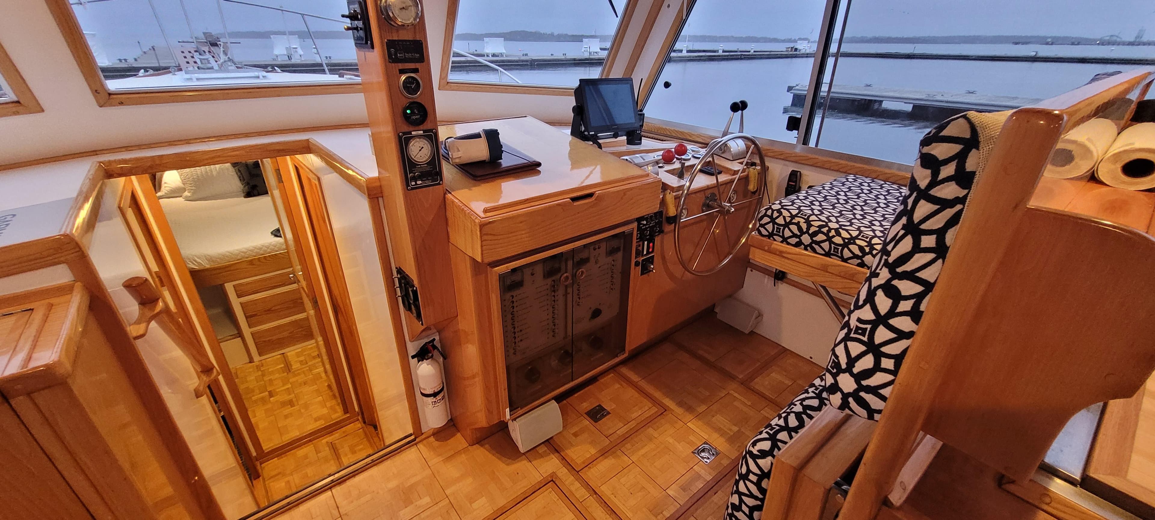 1989 Duffy Wilbur 42 Flybridge Cruiser interior with helm, seating, and wood finish.