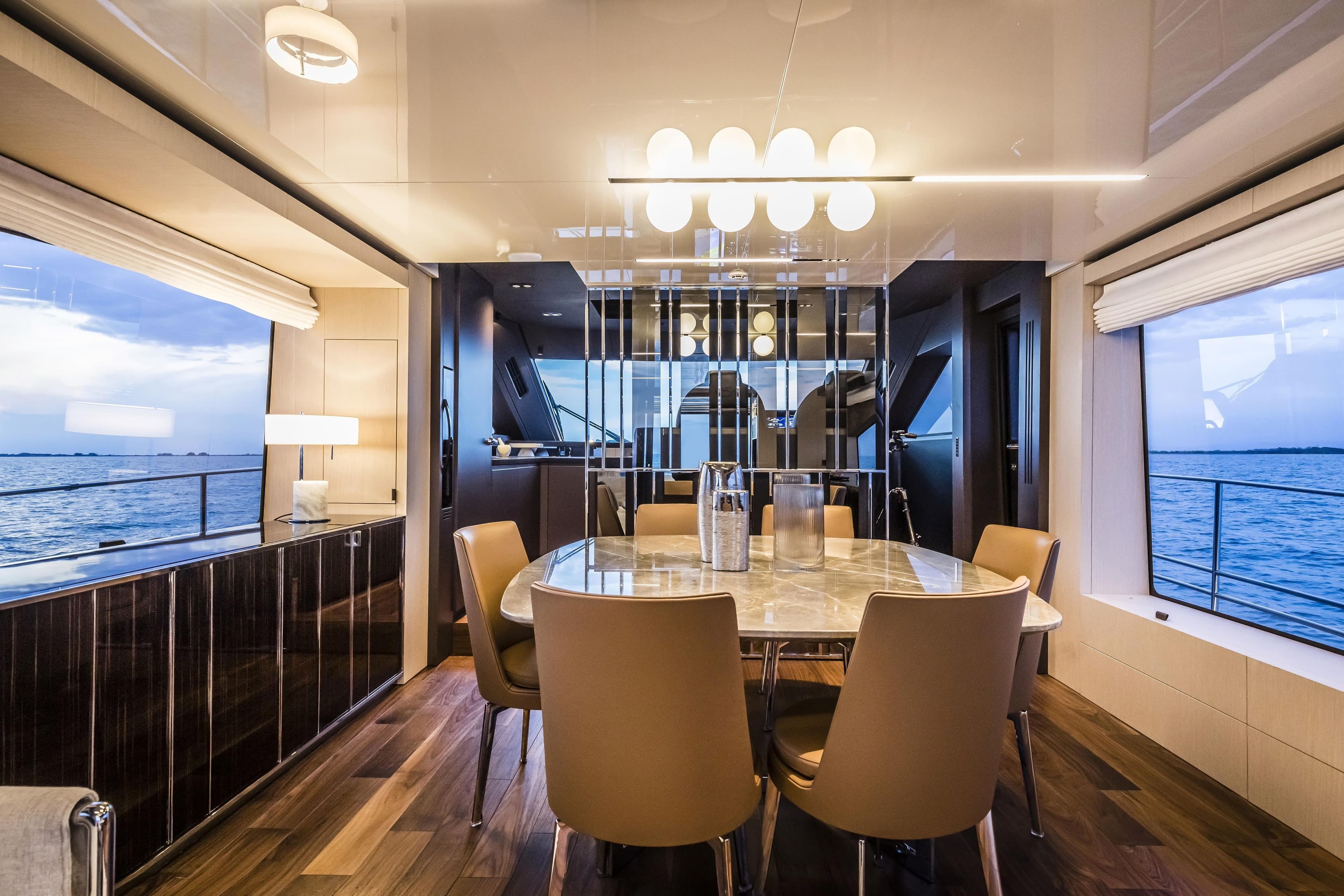 Luxurious interior of 2026 Cranchi Sessantasette 67 Fly yacht with elegant dining area.
