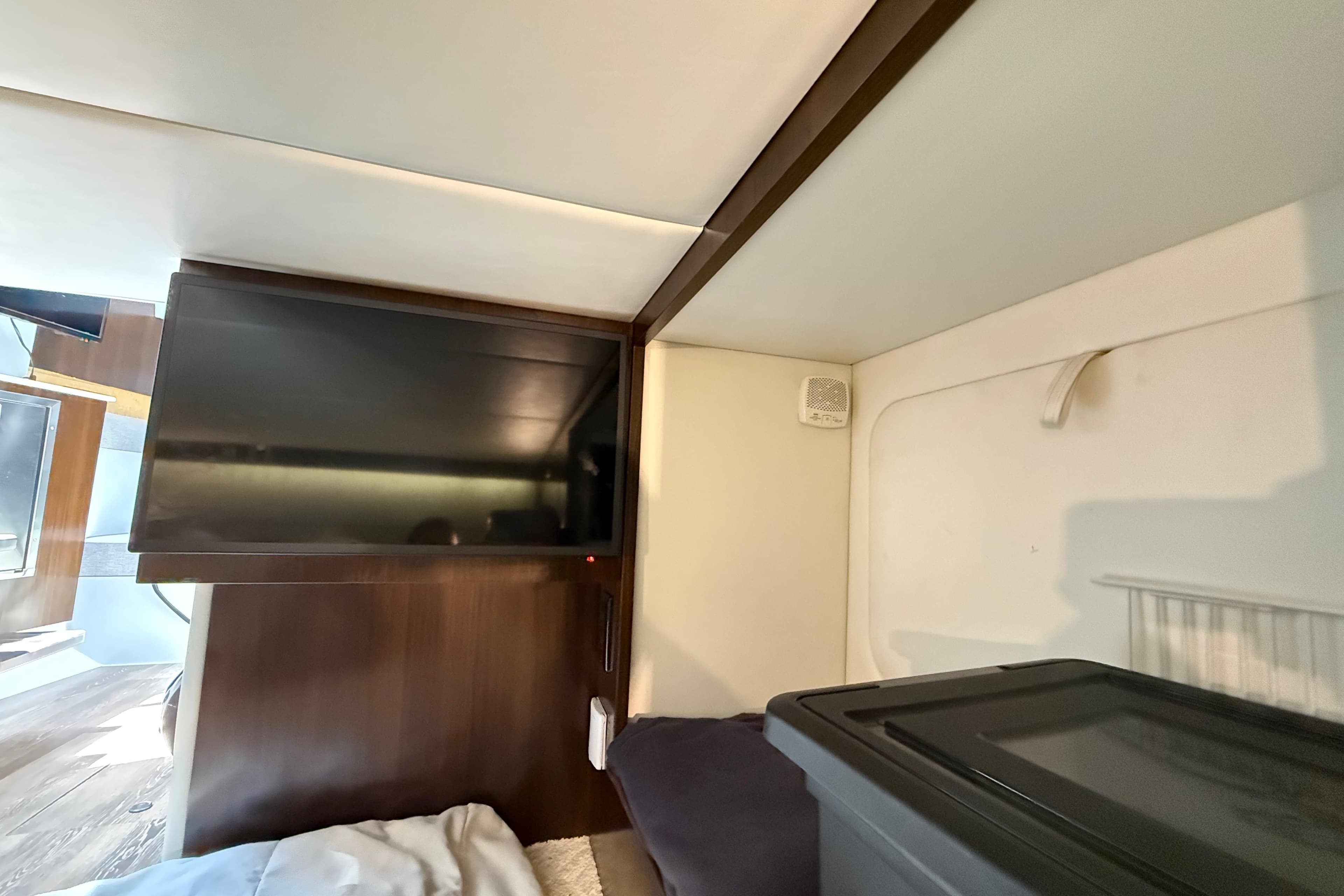 Interior cabin of 2021 Cruisers Yachts 38 GLS OB with TV and storage.
